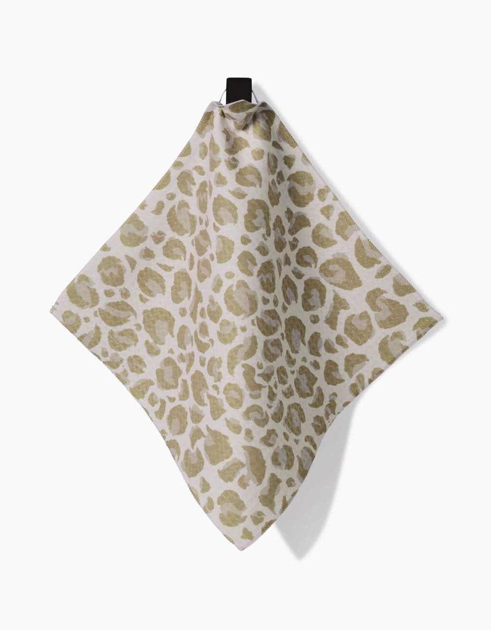 The GEOMETRY Light Leopard, an ultra-absorbent Geoweave cloth featuring a light brown leopard print on beige, hangs from a black hook against a white background.