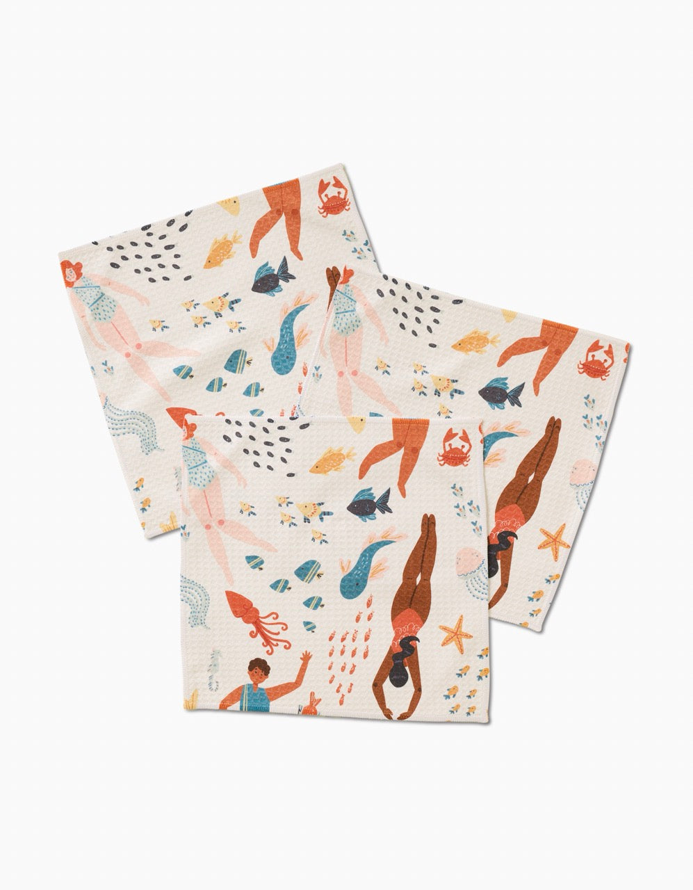 Two folded luxe washcloths from Janna Sue Designs Spirit of the Ocean, featuring a white background with colorful mermaids, fish, crabs, starfish, and ocean plants.