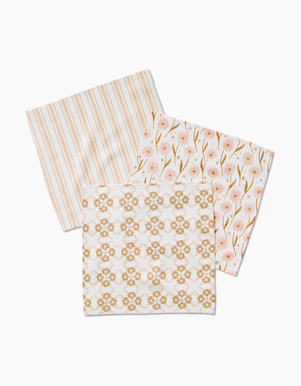 Three Sweet Boho cloth napkins by Hufton Studio, crafted from recycled materials, are arranged overlapping; they feature beige stripes, pink flowers with green stems, and a tan geometric floral design.