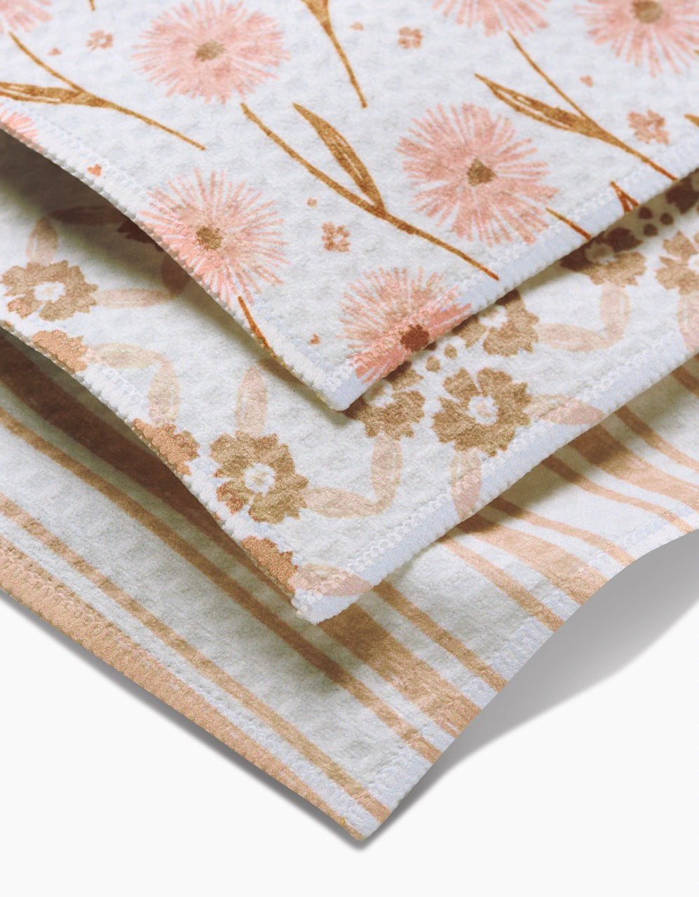 The Hufton Studio Sweet Boho set includes three Luxe Washcloths made from ultra-absorbent recycled materials, featuring pink and orange floral, beige and peach floral, and peach and cream stripe designs on a white background.