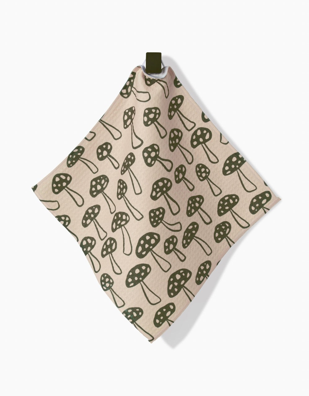 The Kayla Ann Woodland Mushroom washcloth is a beige square made from post-consumer recycled materials, featuring a green mushroom pattern and a hanging loop at the top.
