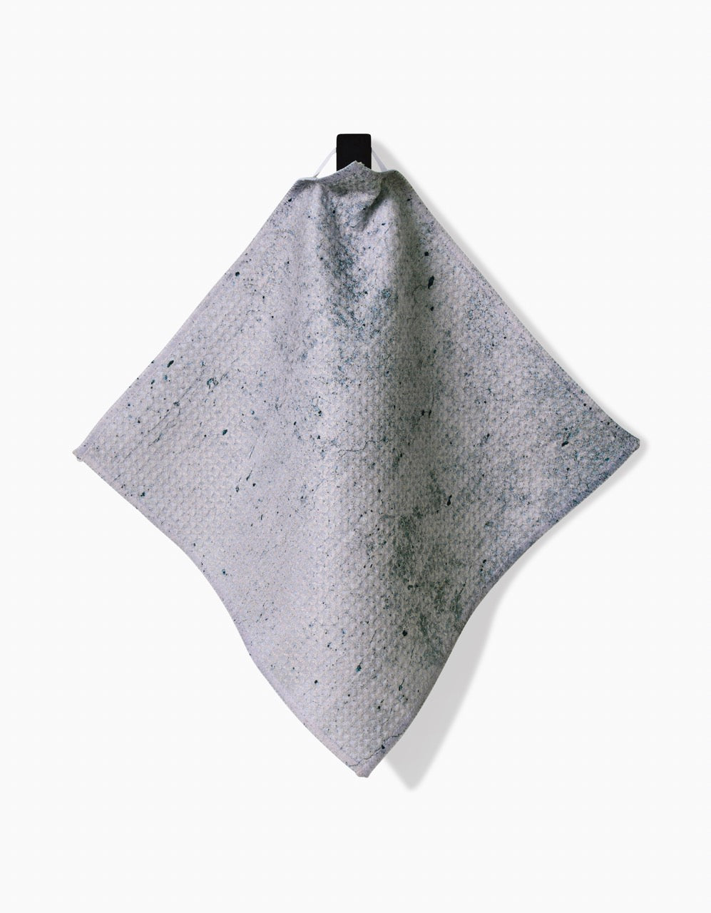 The Wright Set by Kailee Wright features a textured, light gray Geoweave dishcloth with subtle darker speckles, hanging from a black loop against a white background.