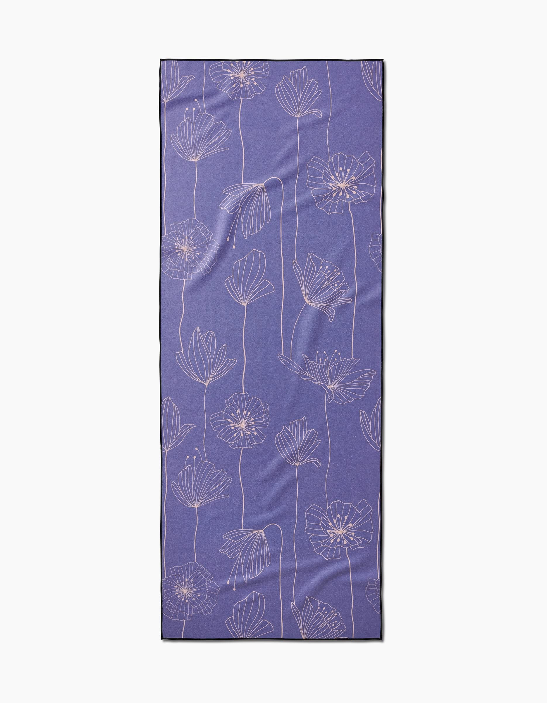 The GEOMETRY Alexa yoga mat is rectangular and purple with a light pink floral pattern of outlined flowers and long stems, made from recycled materials and shown on a white background.