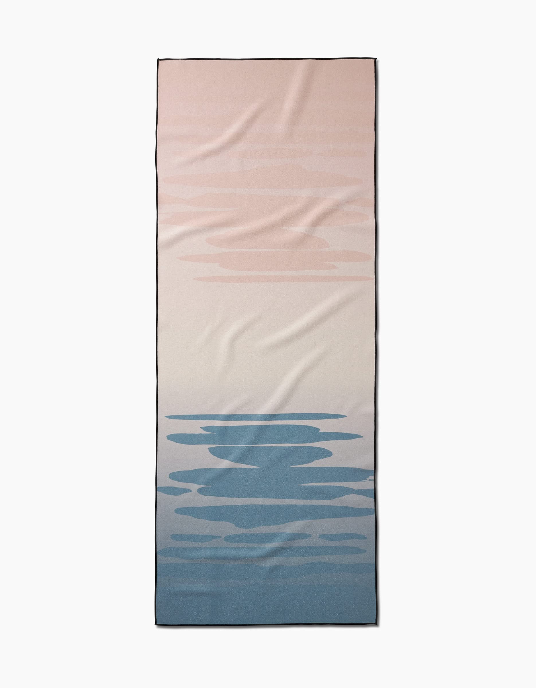 The GEOMETRY Balance yoga towel is rectangular and slip-resistant, featuring a gradient from soft pink to cream and blue with abstract cloud or ripple motifs.