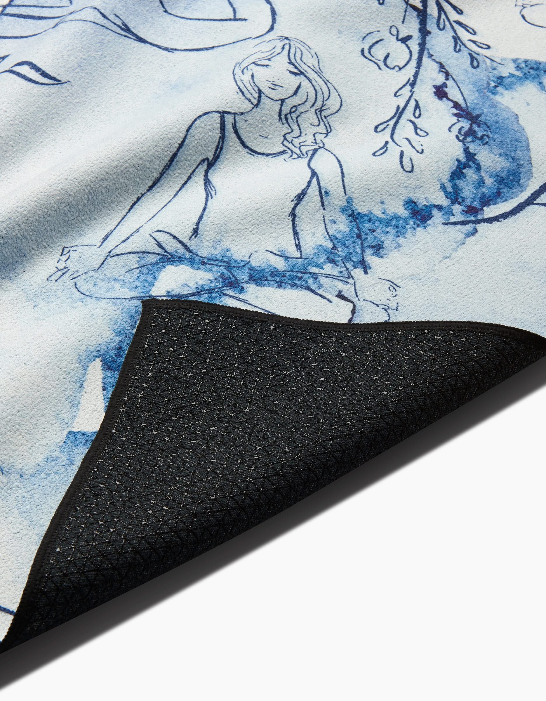A close-up of the Breathe In Breathe Out yoga mat by Elena Fay shows its lifted corner with a black textured underside and a blue watercolor woman meditating amid leafy branches—ideal to pair with your favorite slip-resistant yoga towel.