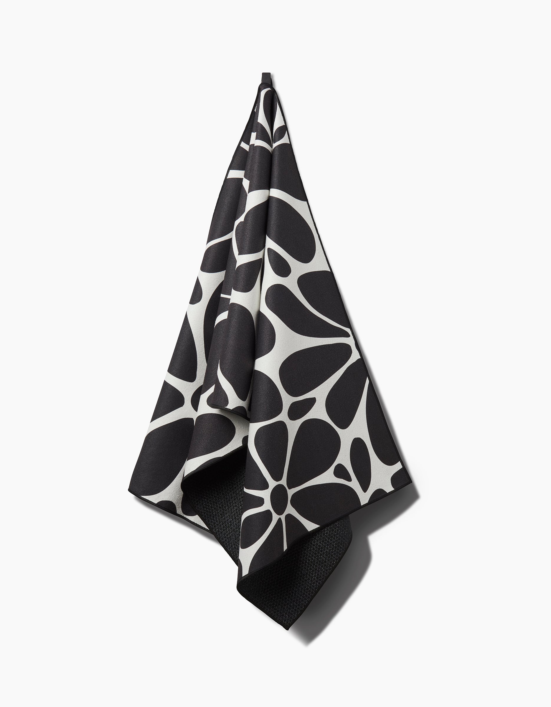 The Cute Flowers yoga towel by GEOMETRY features charming floral patterns on a white background, combining style and sustainability—this recycled towel is both eco-friendly and attractive for your yoga practice.