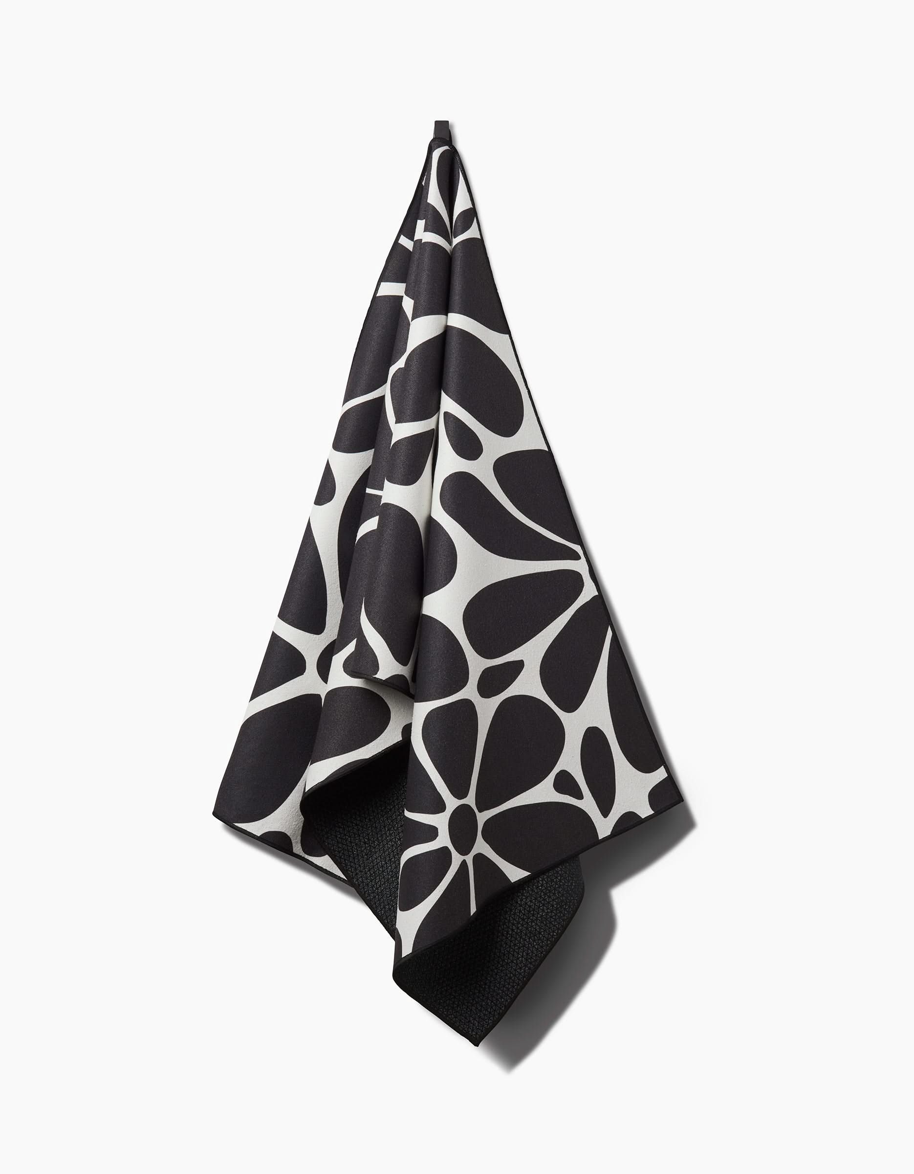 The Cute Flowers yoga towel by GEOMETRY features charming floral patterns on a white background, combining style and sustainability—this recycled towel is both eco-friendly and attractive for your yoga practice.