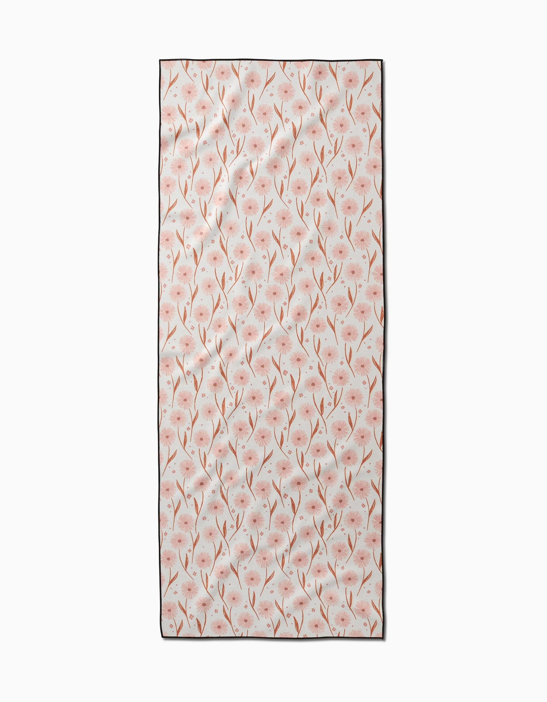 The Daisy Pop yoga towel by Hufton Studio is a rectangular, slip-resistant towel with delicate pink flowers and brown stems on a light background.