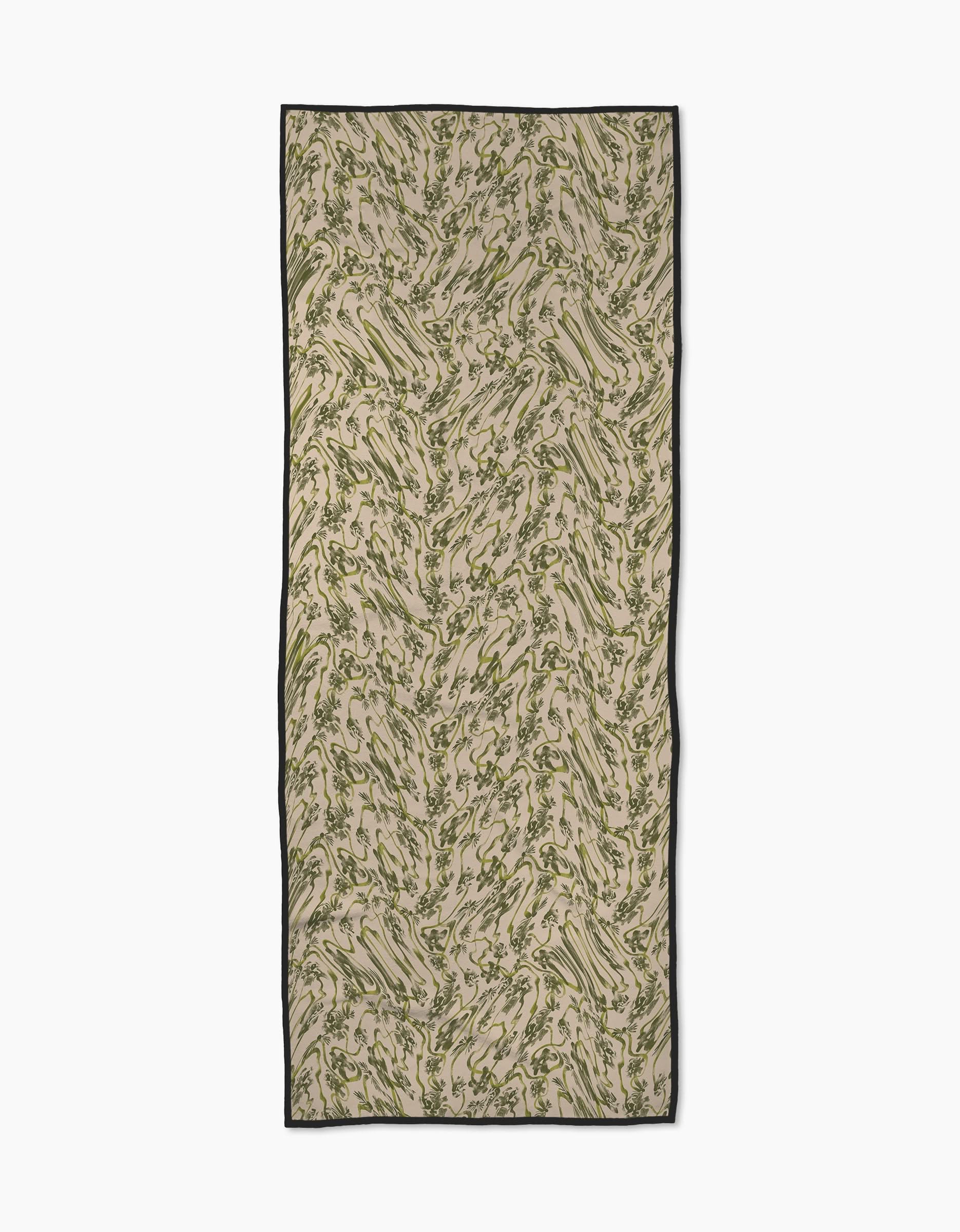 Floral Swirls Green is a rectangular beige scarf made from recycled materials, featuring a green and brown abstract swirl pattern with a thin black border. Its shown flat on a white background.
