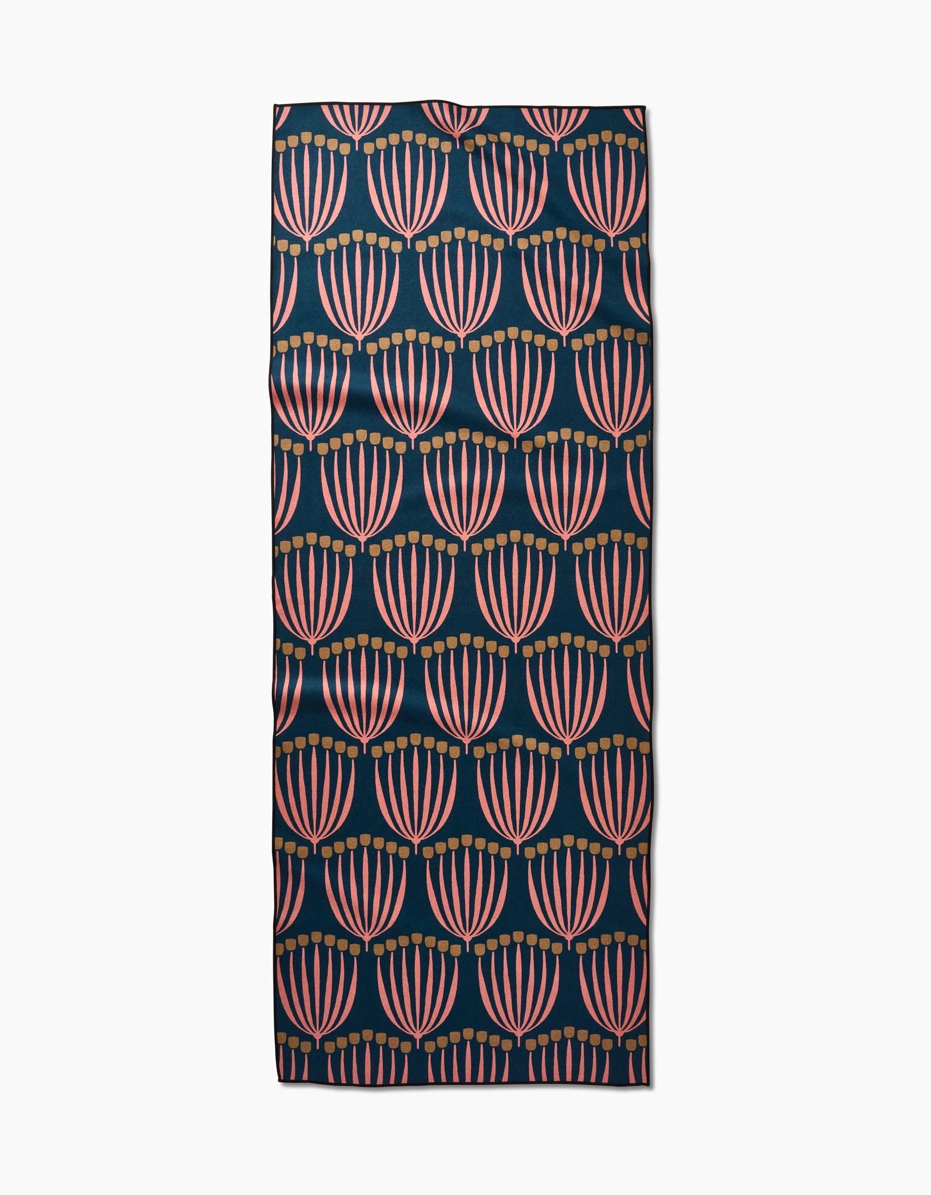 The Josie mat by Amy MacCready features a dark background with a repeating fan-shaped pattern in pink and orange shades, crafted from recycled materials.
