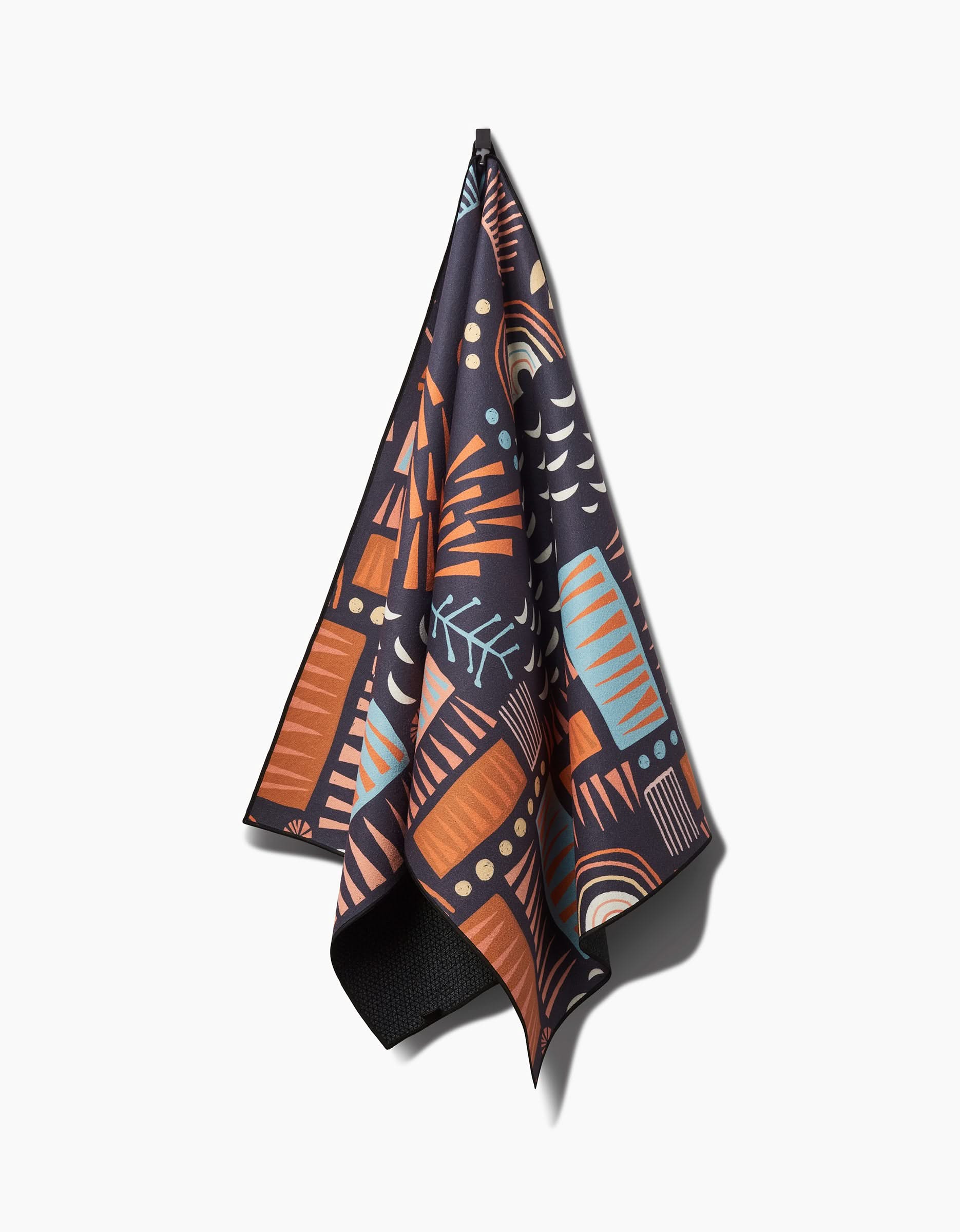 The Keep Showing Up yoga towel by Jessica Swift showcases a bold abstract pattern with orange, blue, and beige shapes on a white background. Made from recycled materials for an eco-friendly touch.