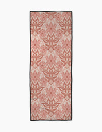 The Lily Nouveau yoga towel by Sarah Daugherty features a recycled, rectangular design with large pink and red floral patterns outlined in red, subtle dot accents on a light background, and a black border.