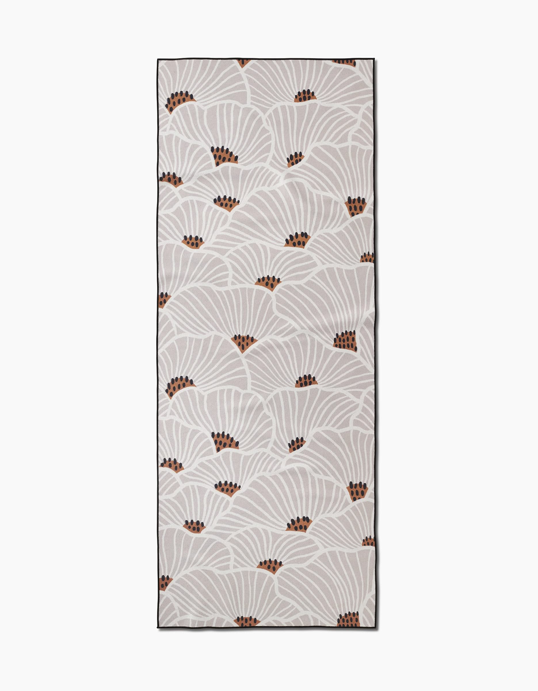 The San Diego yoga towel by Amy MacCready is rectangular and beige, featuring white fan-shaped leaves with brown dots and a dark border. Made from recycled materials for an eco-friendly touch.