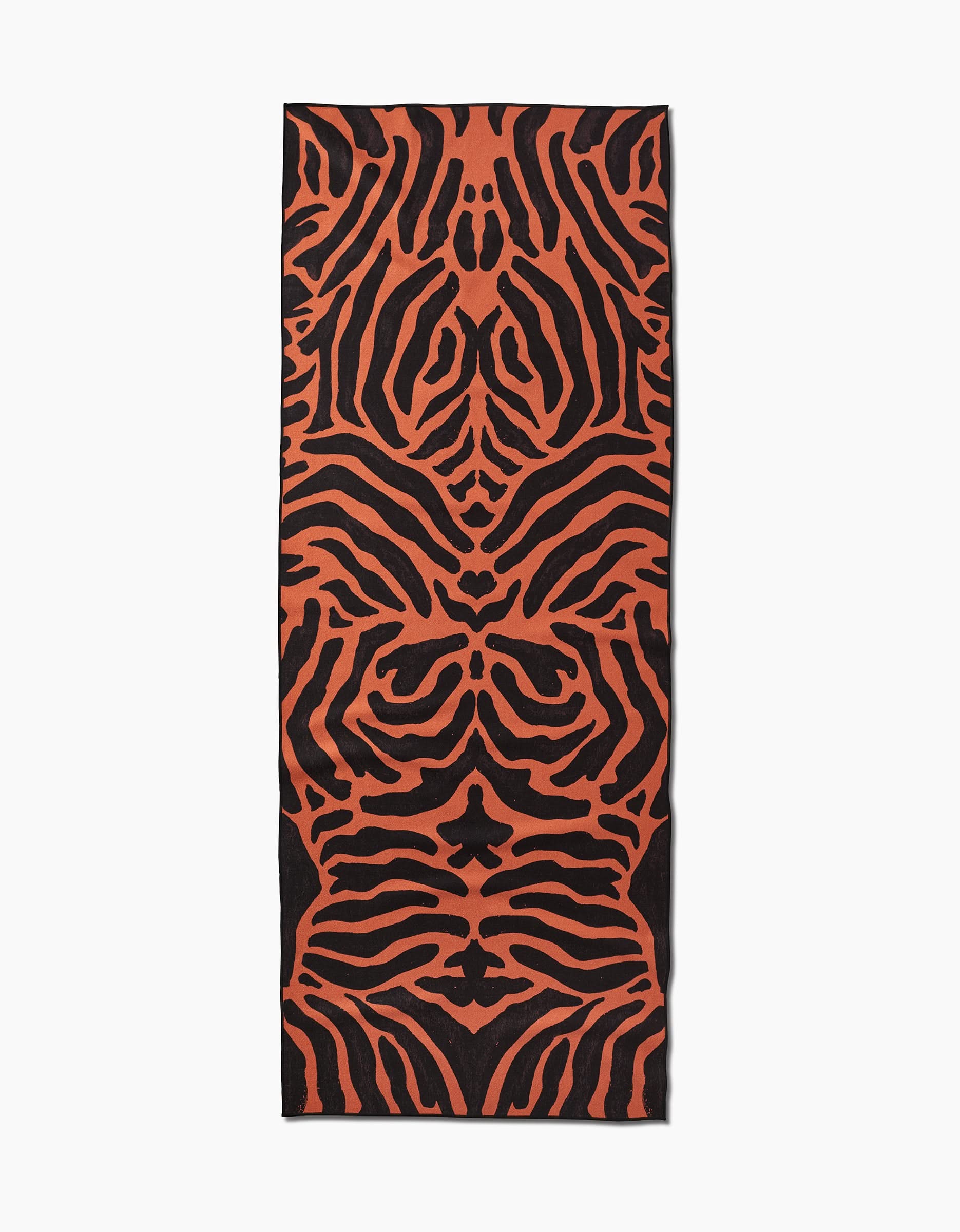 The GEOMETRY Tiger is a rectangular yoga towel with an orange and black tiger stripe pattern, made from recycled materials and shown flat on a white background.