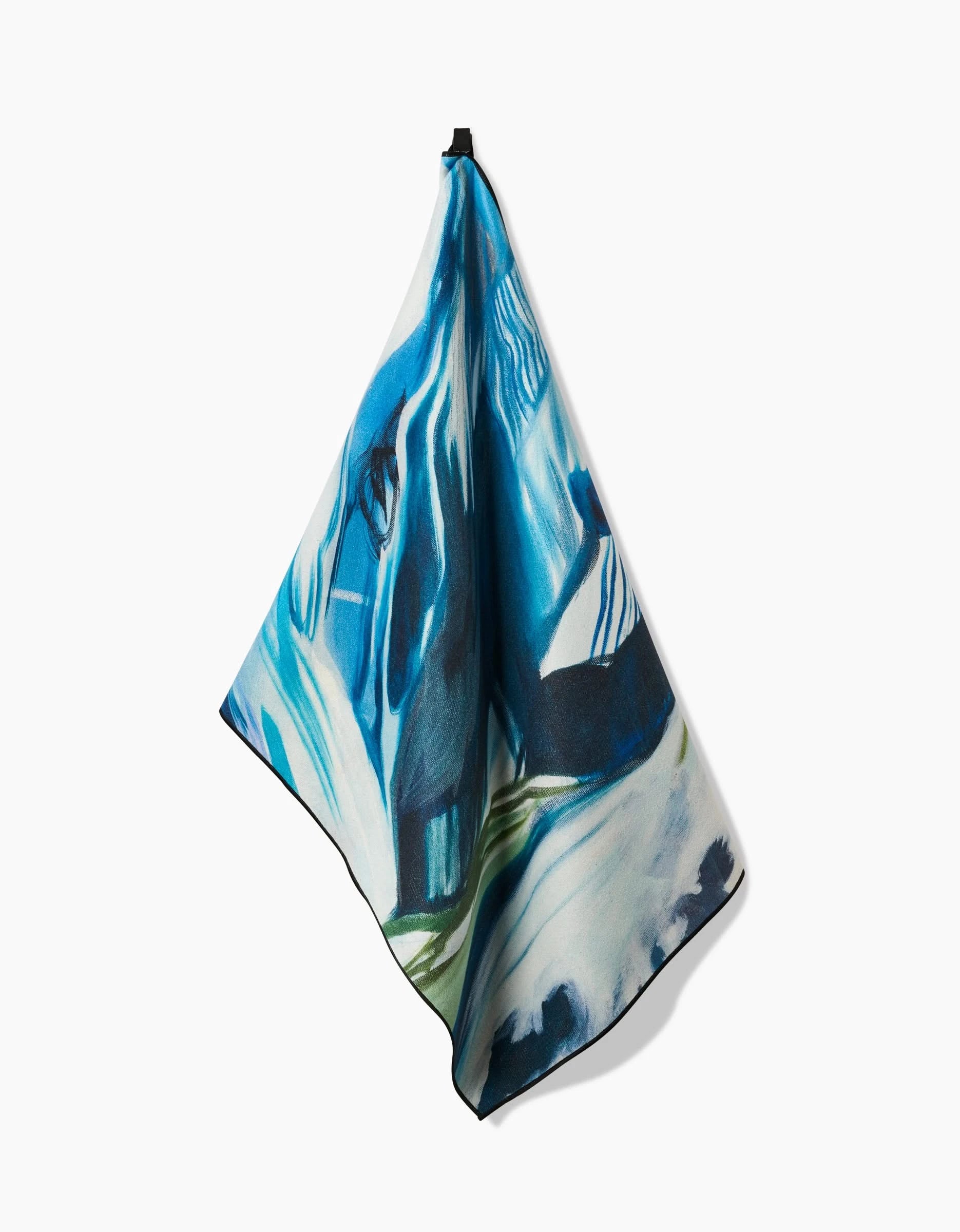 The Where He Laid To Go square yoga towel by Kelly Peters, made from recycled materials and displaying abstract blue, white, black, and green patterns, is shown hanging from a single point against a plain white background.