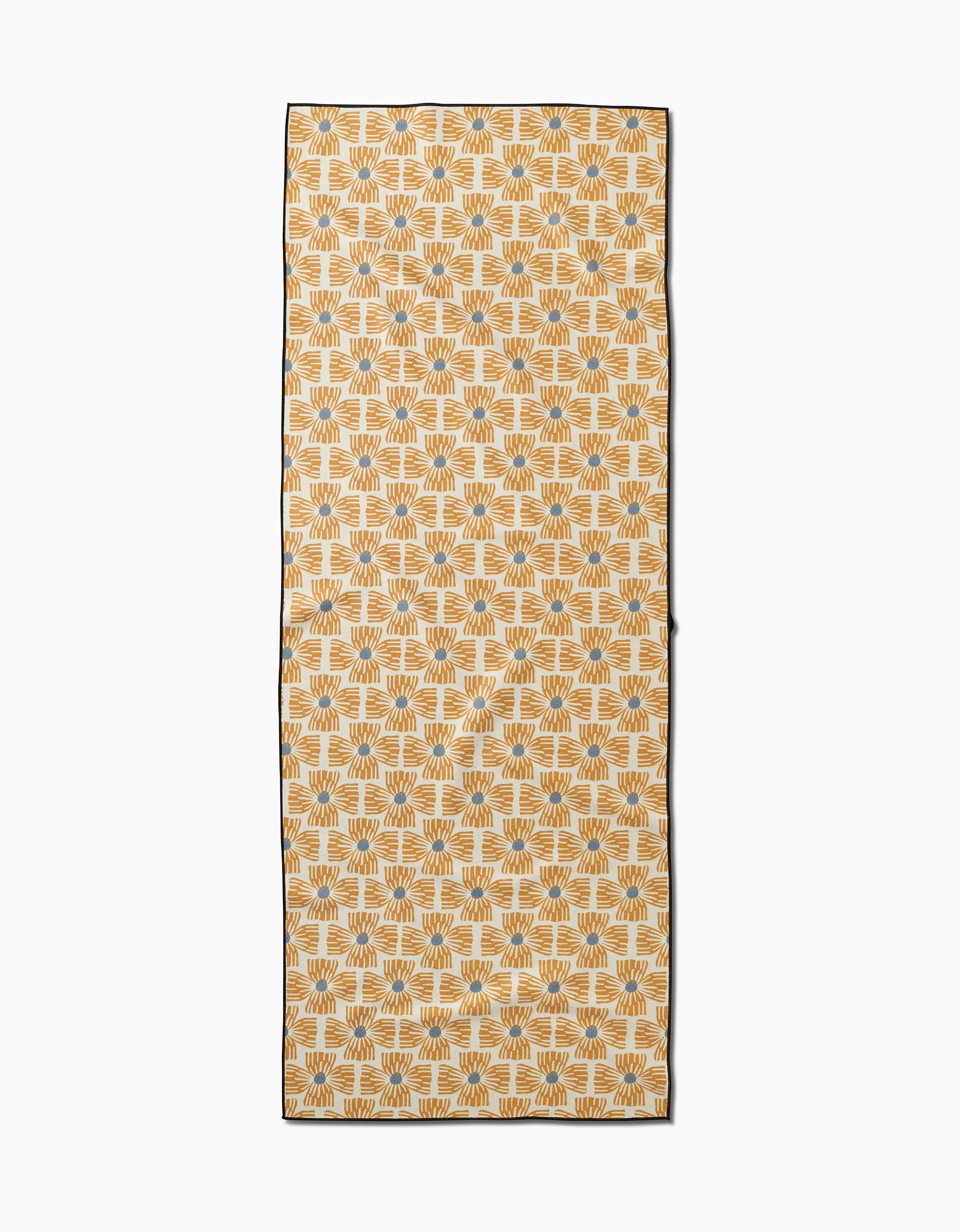 The Ash Cascade Wildflower yoga towel features a repeating geometric leaf pattern in mustard yellow and gray on white, bordered by a thin black edge and made from recycled materials.