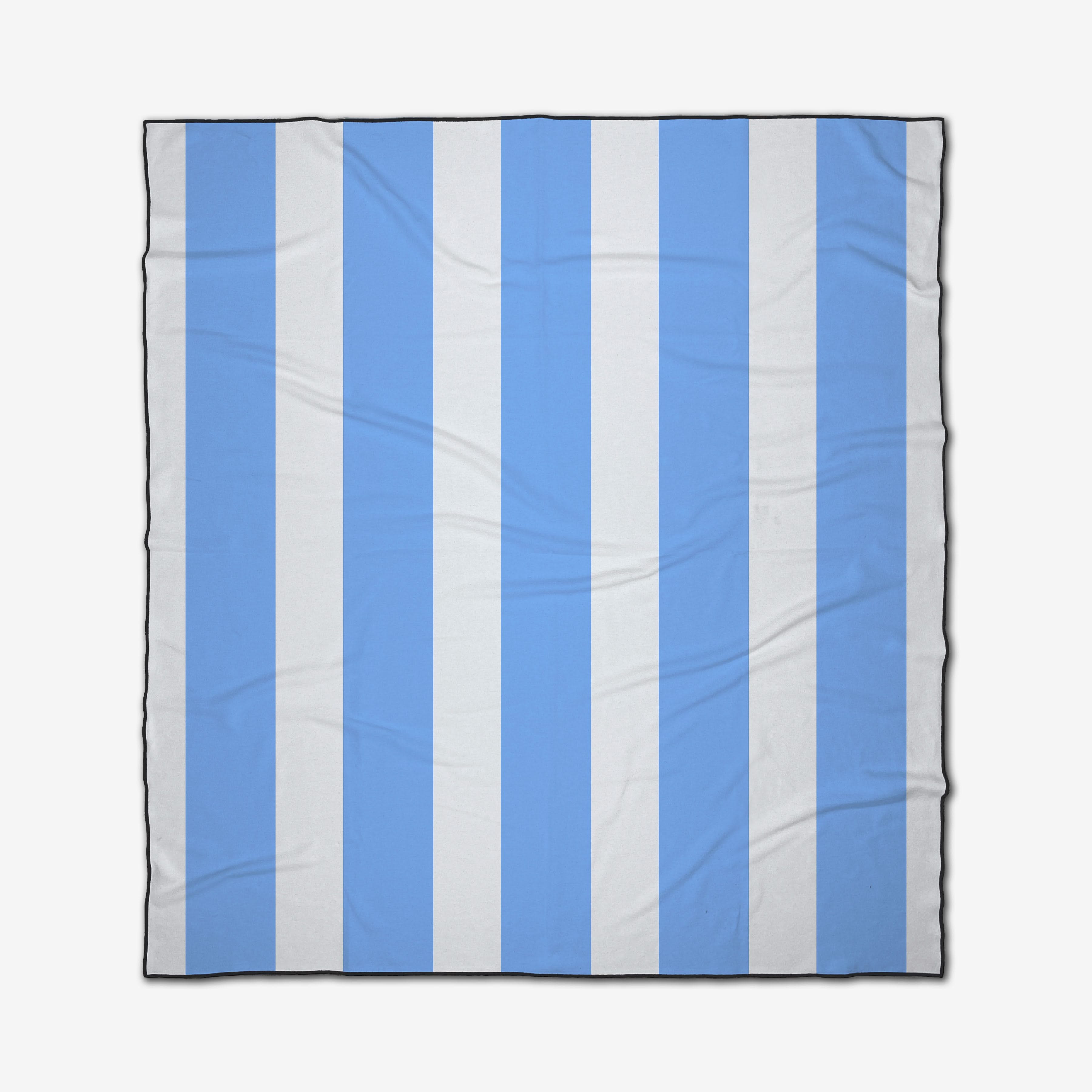 The GEOMETRY Blue Block Stripes is a square beach blanket with alternating vertical light blue and white stripes, black-bordered edges for style, made from recycled materials with slight folds and creases.