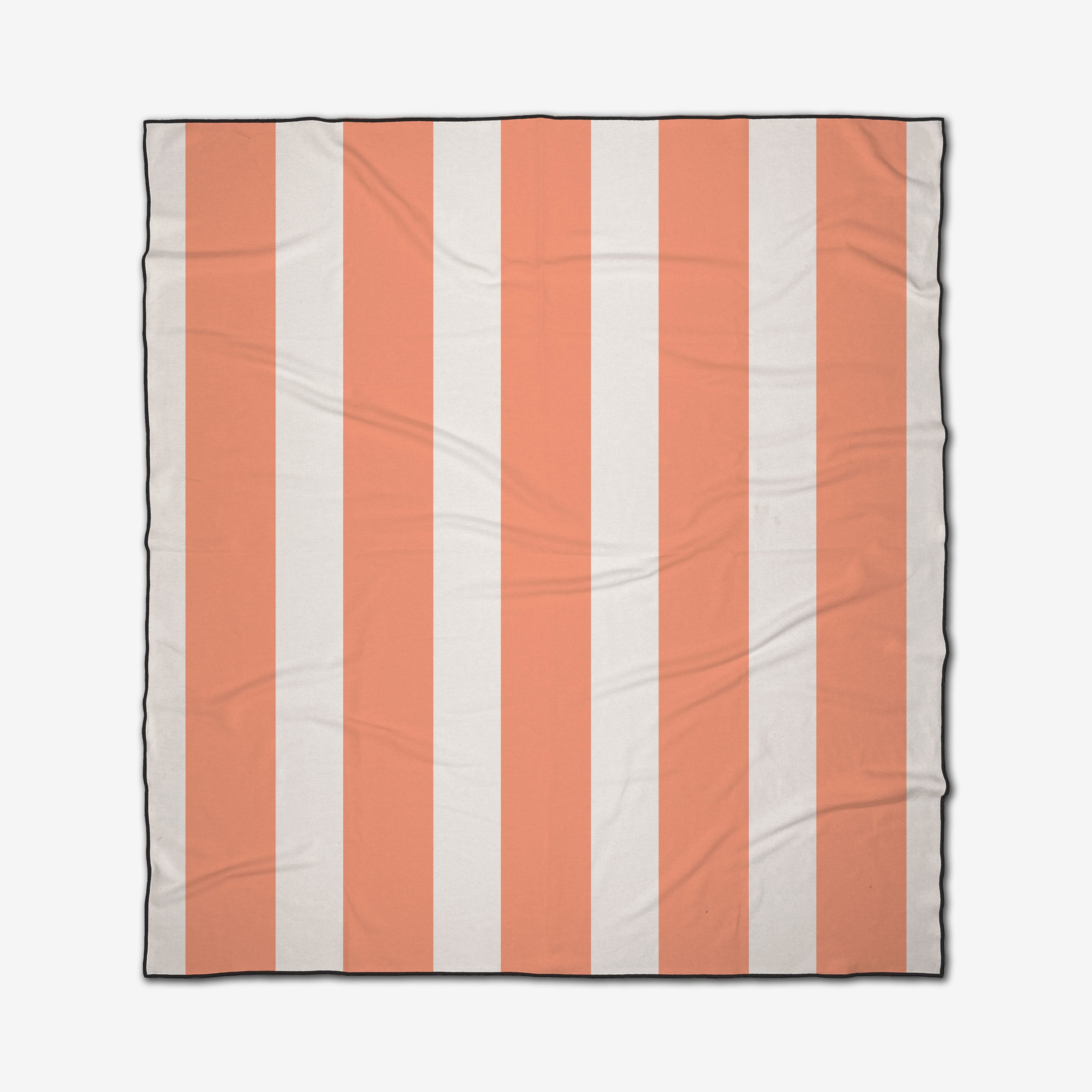 The GEOMETRY Coral Block Stripes is a square, quick-drying beach blanket with light orange and white vertical stripes, a thin black border, and a slightly wrinkled fabric appearance.
