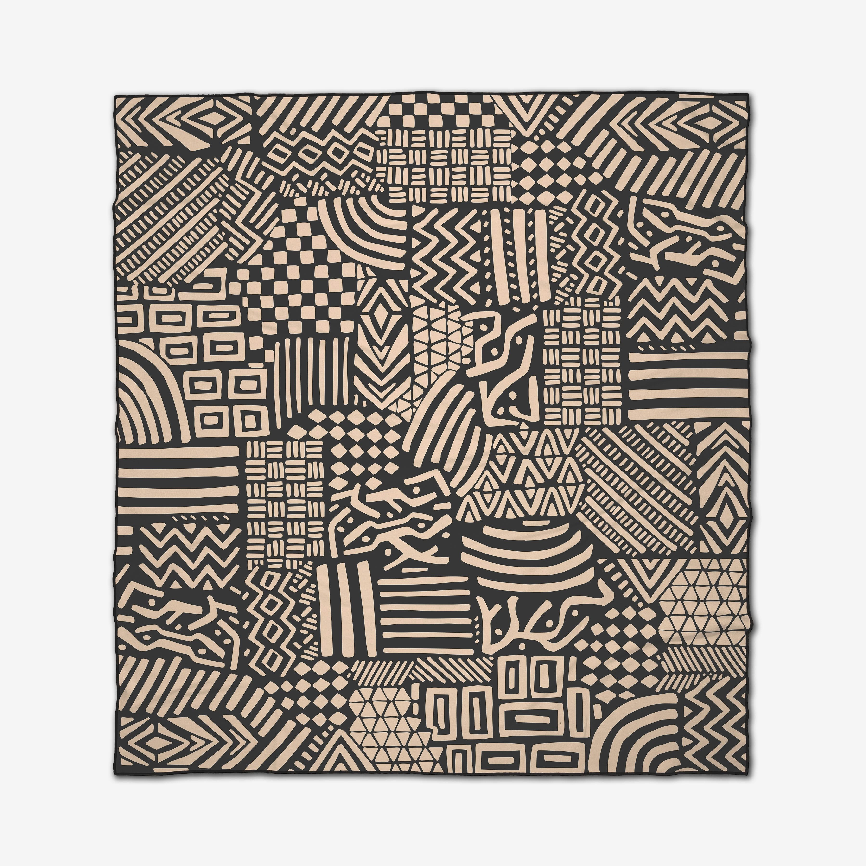 The GEOMETRY Shape Shift Micro-loop Beach Blanket showcases a stylish patchwork of black and beige geometric shapes—lines, zigzags, squares, rectangles, and curves—in a modern rectangular design.