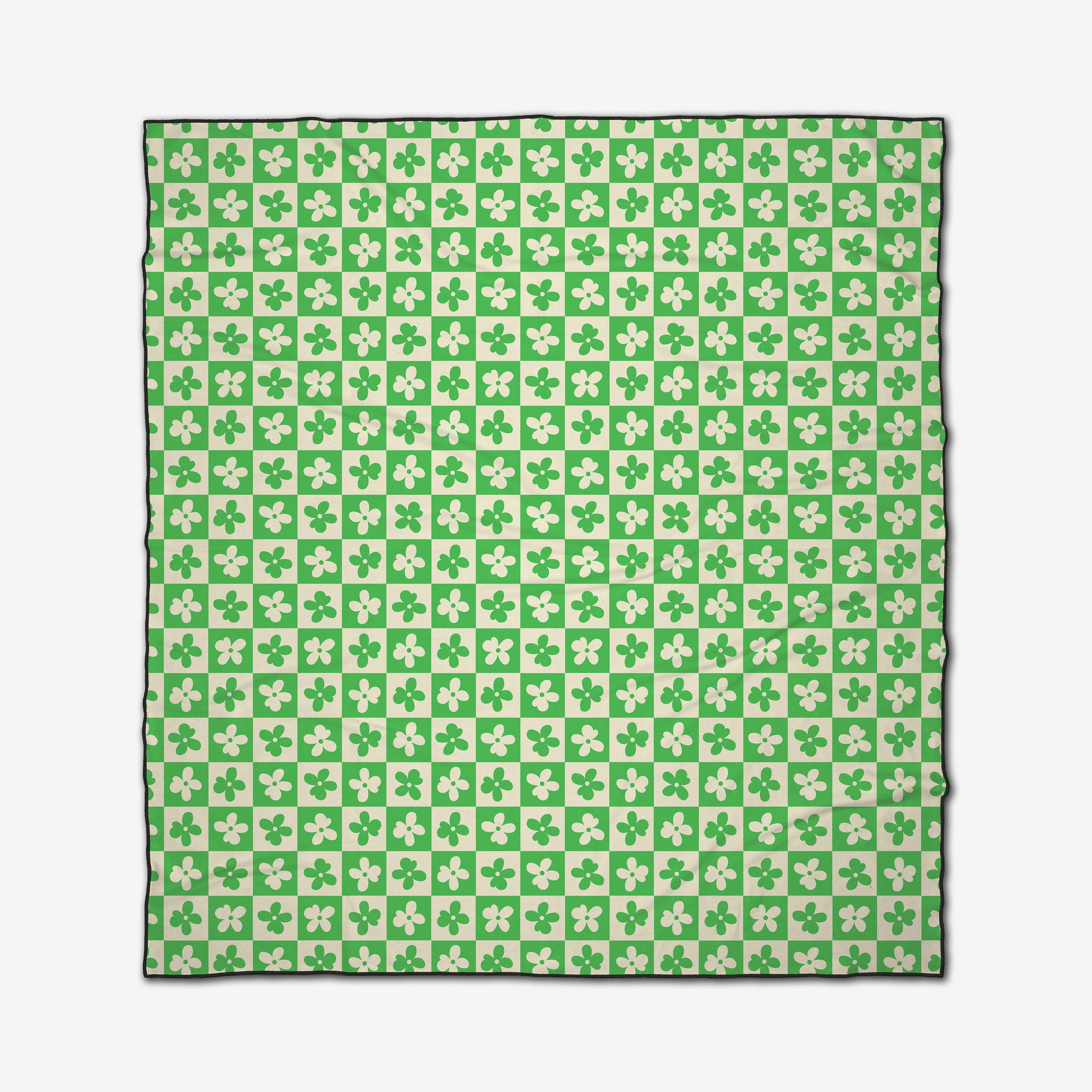 The GEOMETRY Spearmint Green Flowers Beach Blanket features a square checkerboard pattern in green and white with four-leaf clovers, a sleek black border, quick-drying recycled materials.