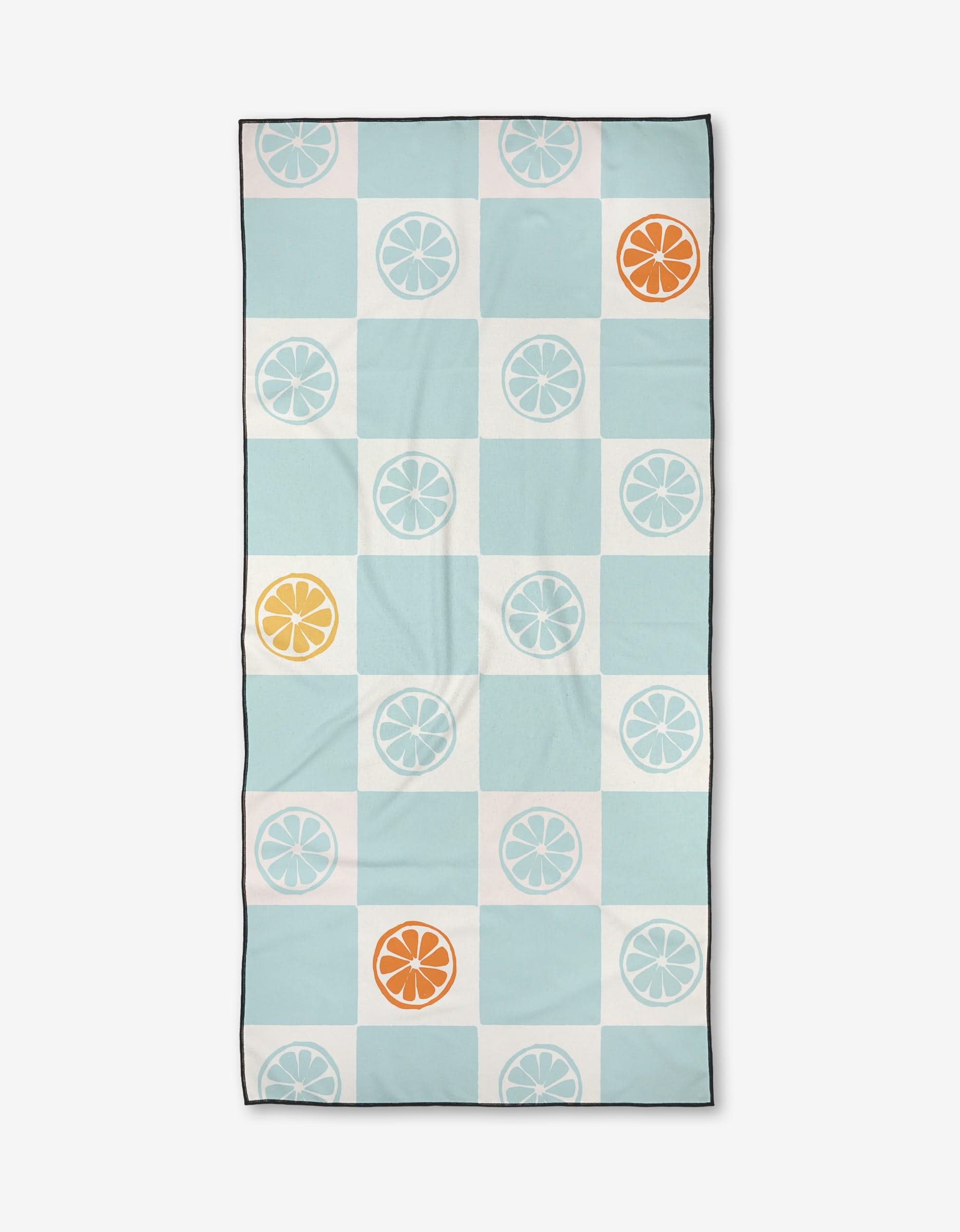 The Citrus Blue beach towel by Janna Sue Design features a grid of blue, white, and teal squares with citrus slice motifs in white, orange, and yellow. Made from recycled materials, it has a thin black border.
