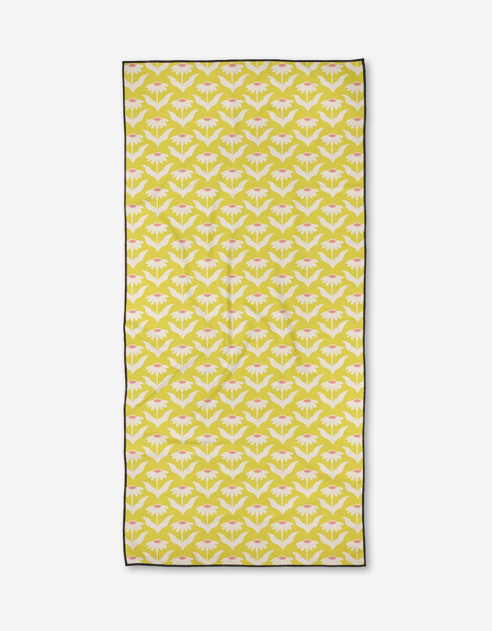 The Kayla Ann Coneflower is a rectangular yellow beach towel with a white and pink floral pattern, thin black border, and quick-drying recycled materials. Displayed on a white background.