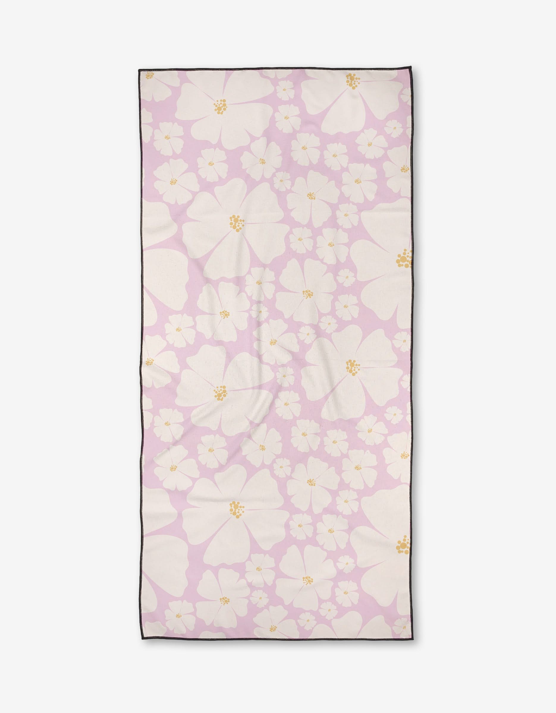 The Daisy Girl Pink towel by Charlie Rowan Designs is a rectangular, ultra-absorbent towel in light pink with white and pale yellow flowers, finished with a dark border.