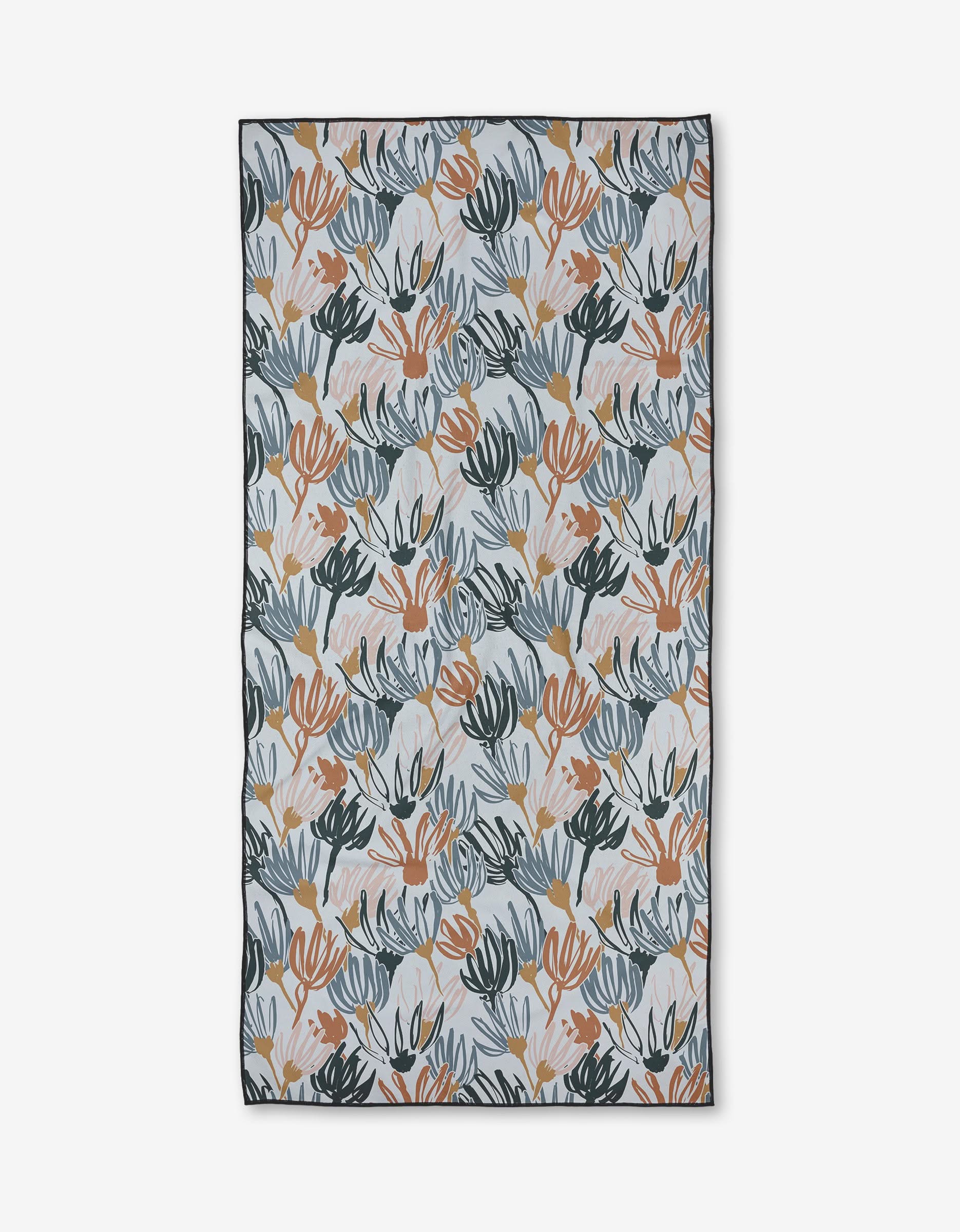 The Sunshine beach towel by Toboggan Avenue features a recycled rectangular design with an abstract leaf pattern in blue, orange, peach, and beige on light gray. Quick-drying and finished with a dark border for a sleek look.