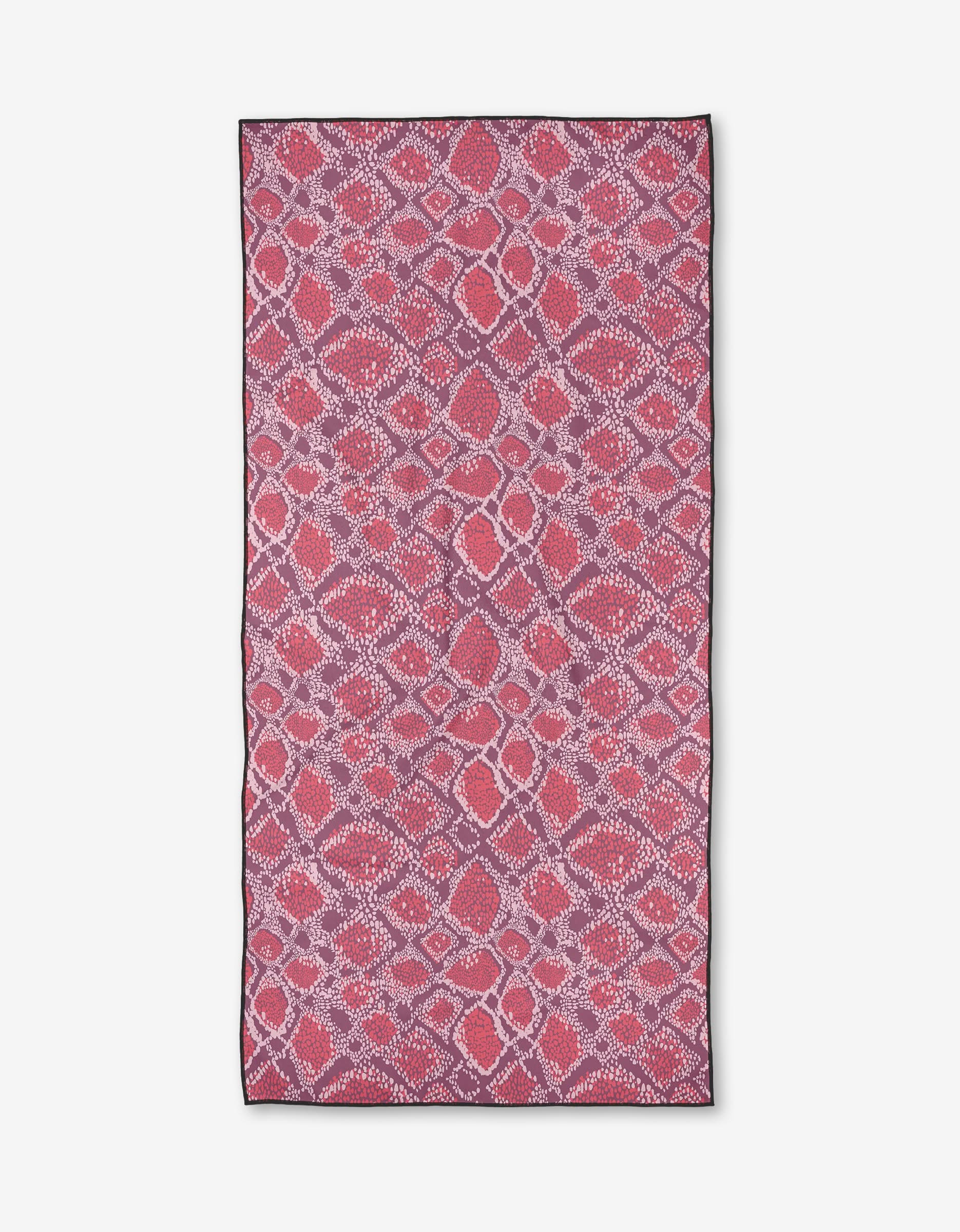 The Elisabeth Wing Vibrant Venom towel features an intricate mosaic-like pattern with overlapping red, pink, and white shapes, giving a textured look of abstract dots and lines.