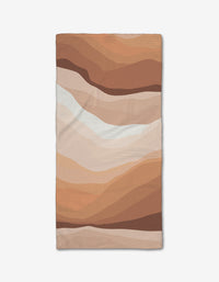 The GEOMETRY “Levels of Fall” Bar Towel features an abstract wavy pattern in brown, beige, and tan, resembling layered earth. Made from ultra-absorbent Geoweave fabric with flowing lines and a textured surface.