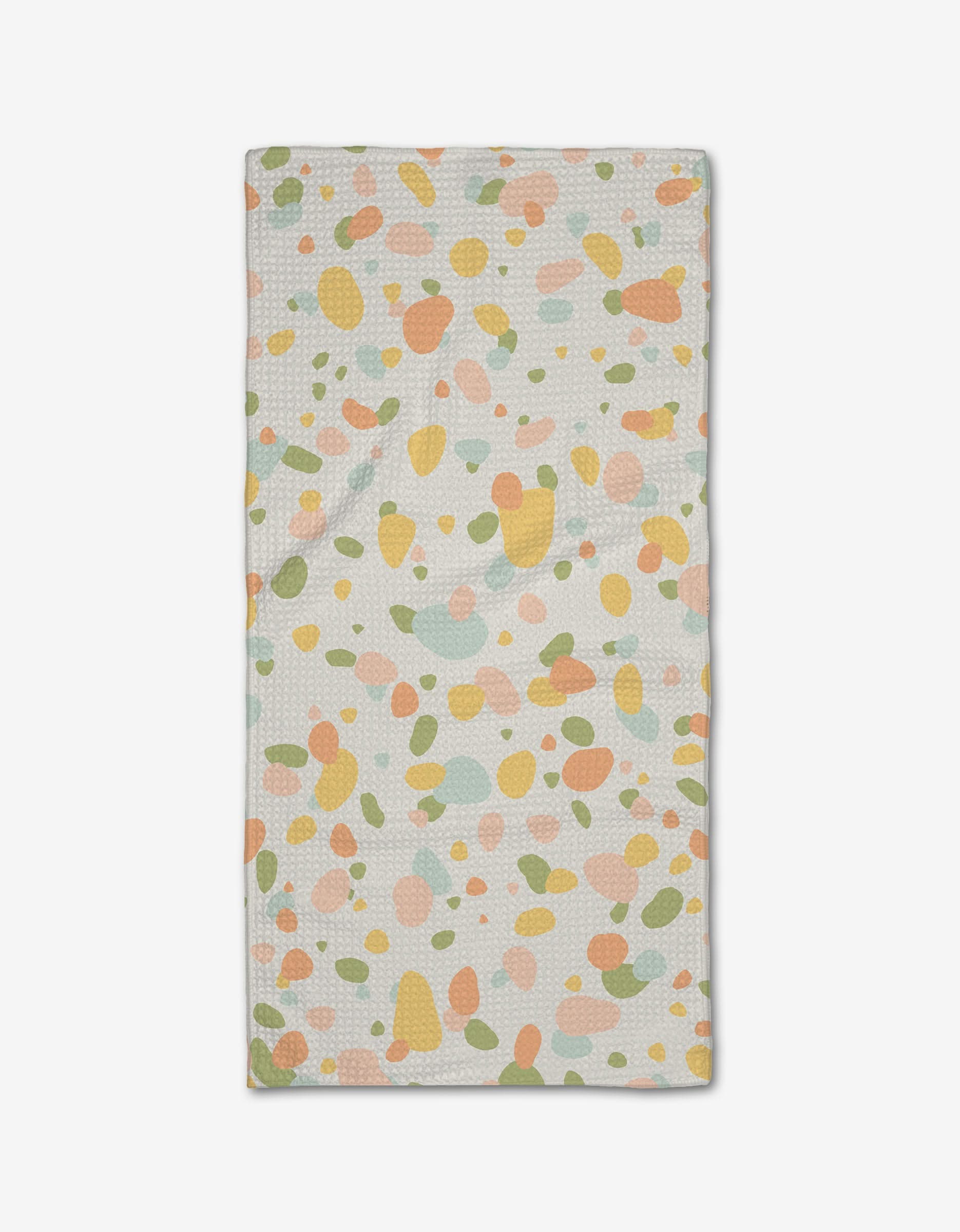 The Rainbow Freckles Bar Towel by Sweet Simple Vegan features a white background with abstract pastel spots in orange, green, yellow, and pink, and is crafted from absorbent Geoweave fabric.