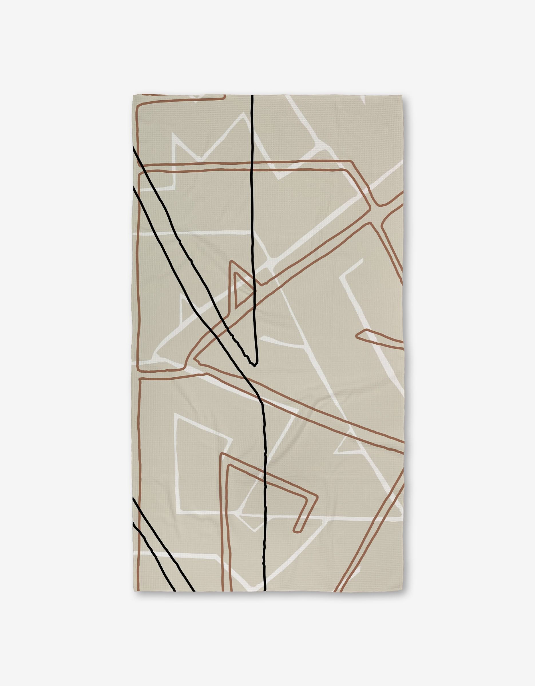 The GEOMETRY Journey rug features a rectangular beige design with abstract, overlapping lines in black, brown, and white on a plain background—crafted from recycled materials for an eco-friendly touch.