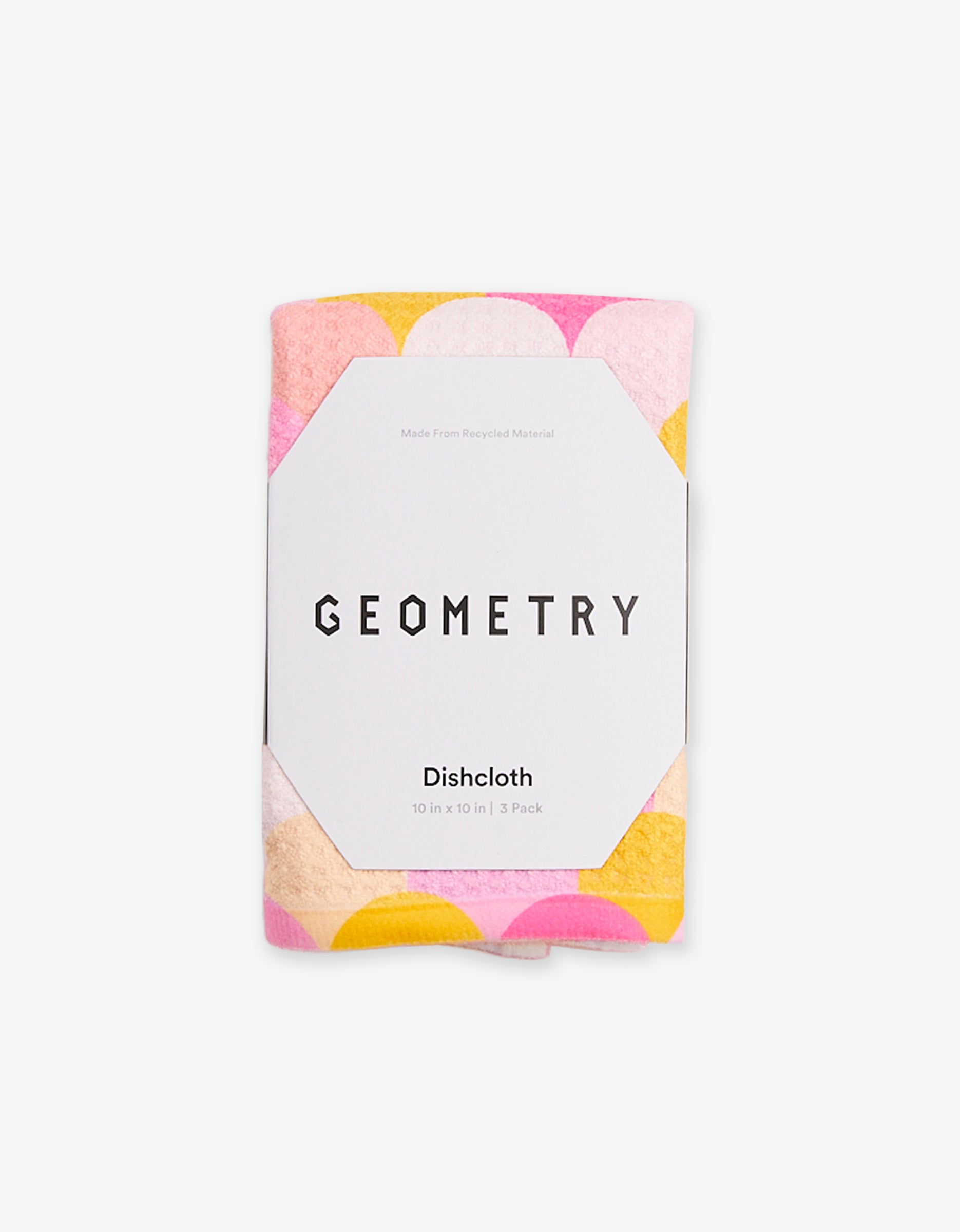 The Inherit Dishcloth Set by GEOMETRY features a white label and vibrant yellow, pink, and peach circular patterns. Its crafted from Geoweave fabric made with recycled materials.