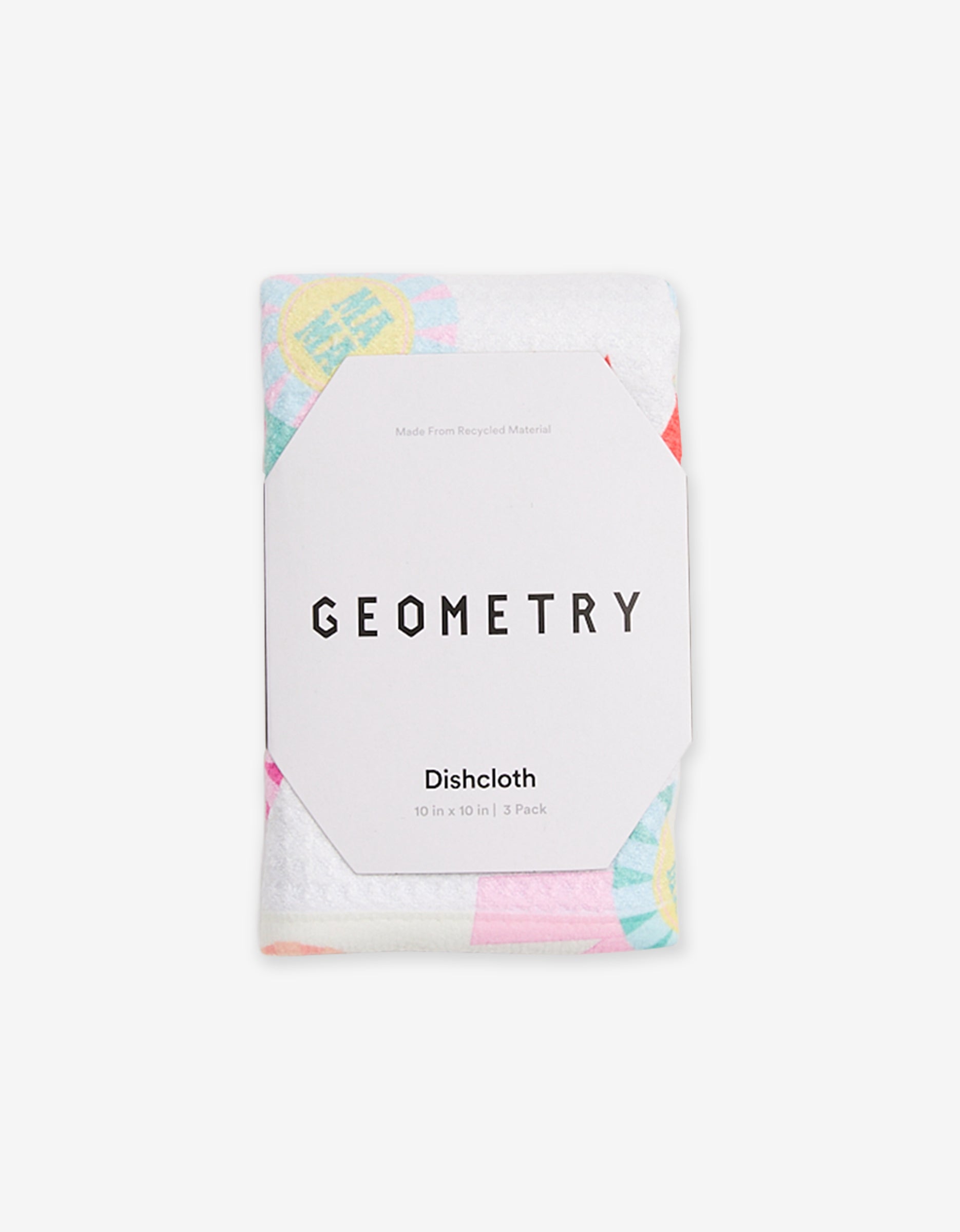 A folded GEOMETRY Mom Mantra dishcloth, 10 x 10 in | 3 Pack, wrapped in white packaging. Made from recycled materials, pastel-colored patterns can be seen beneath the wrapper.