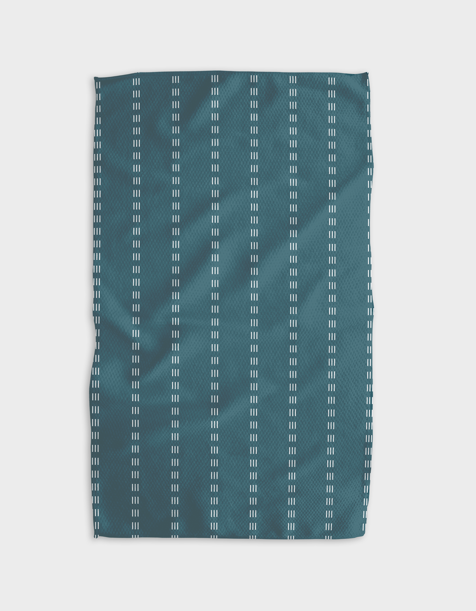 The Buy Guide’s Dashing - Emerald tea towel features emerald Geoweave fabric with evenly spaced white dash stripes, creating a simple geometric look. Made from recycled materials and set against a white background for added contrast.