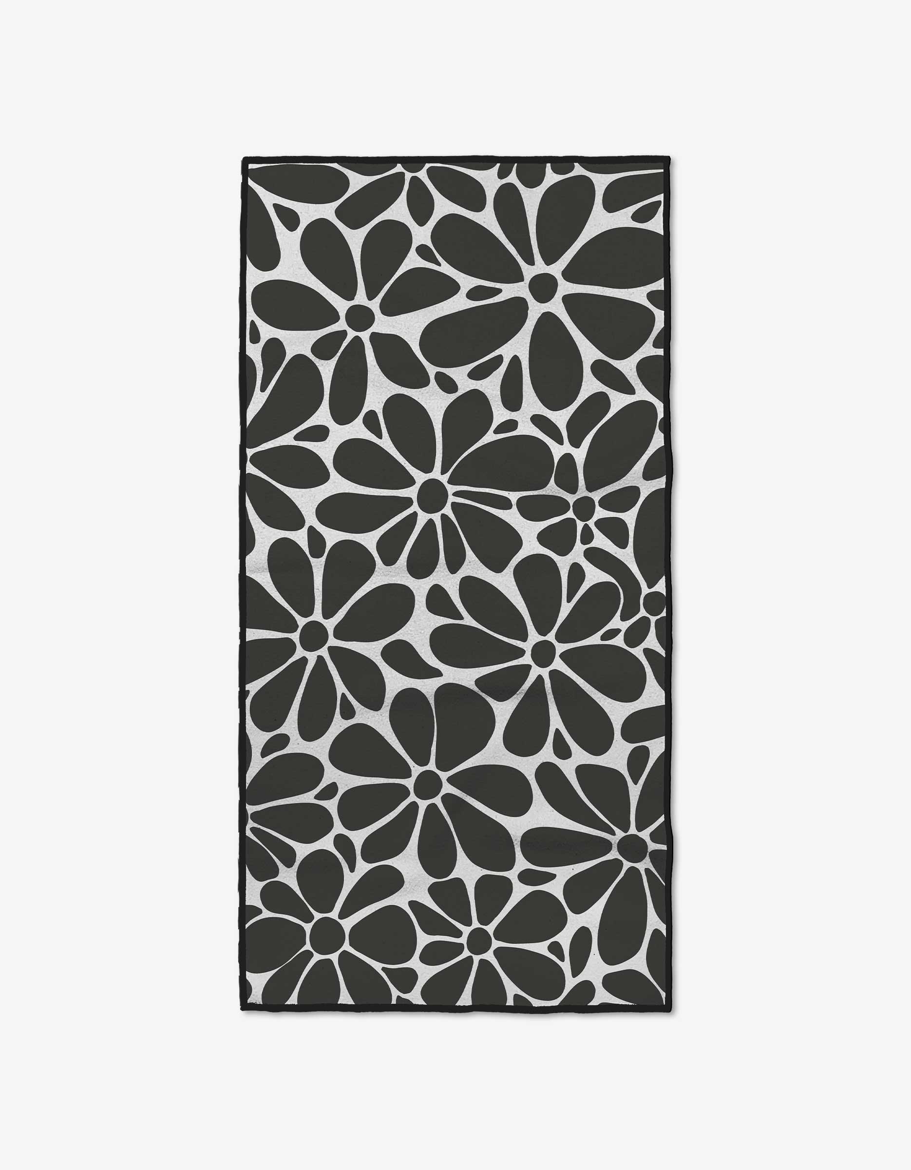 The Cute Flowers mat by GEOMETRY features a bold black and white daisy design on a light background, crafted from recycled materials.