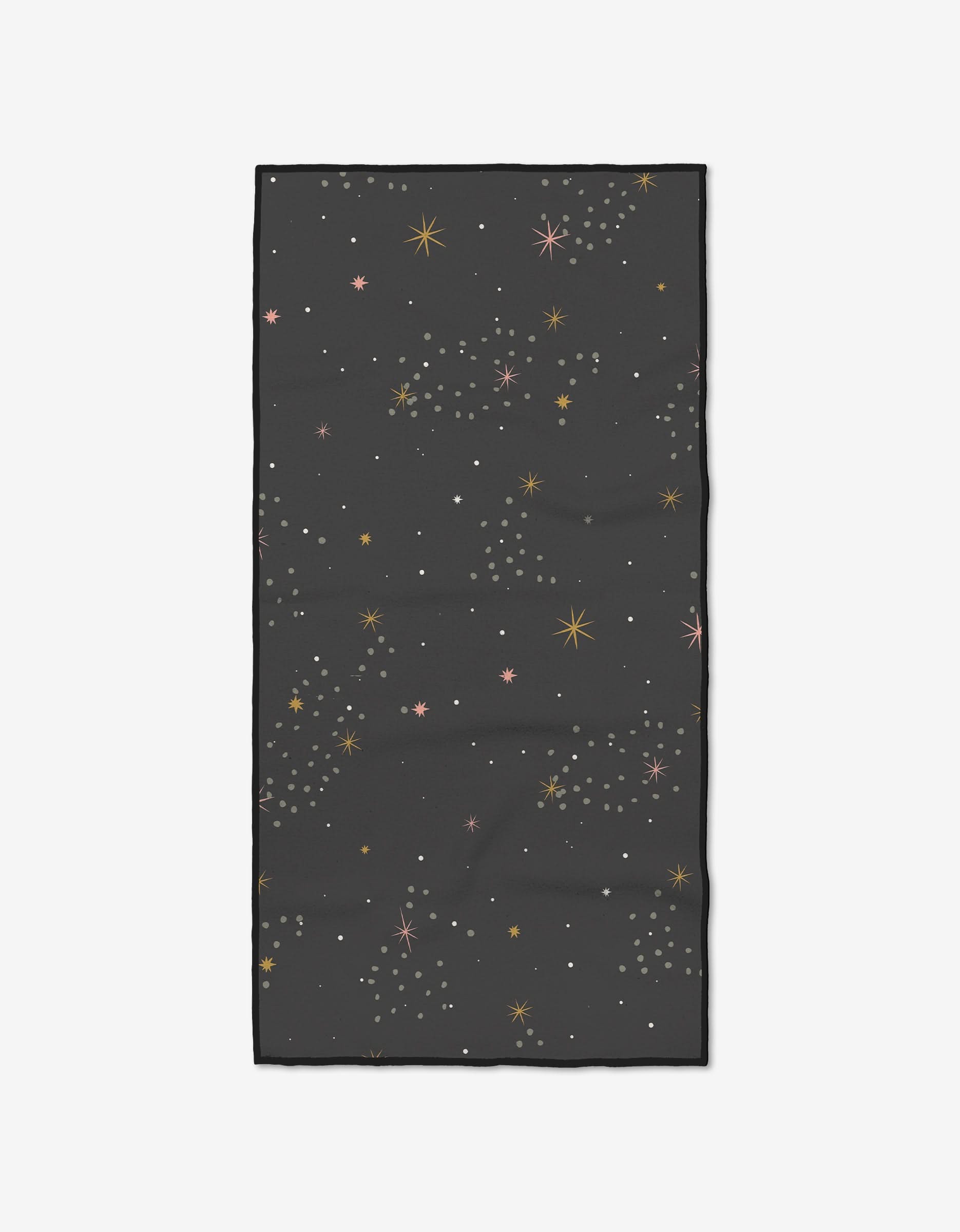 The Ash Cascade Galaxy Burst Fitness Towel is rectangular and black, with a scattered gold, pink, and white star and dot pattern. Made from ultra-absorbent recycled materials for sustainable workouts.