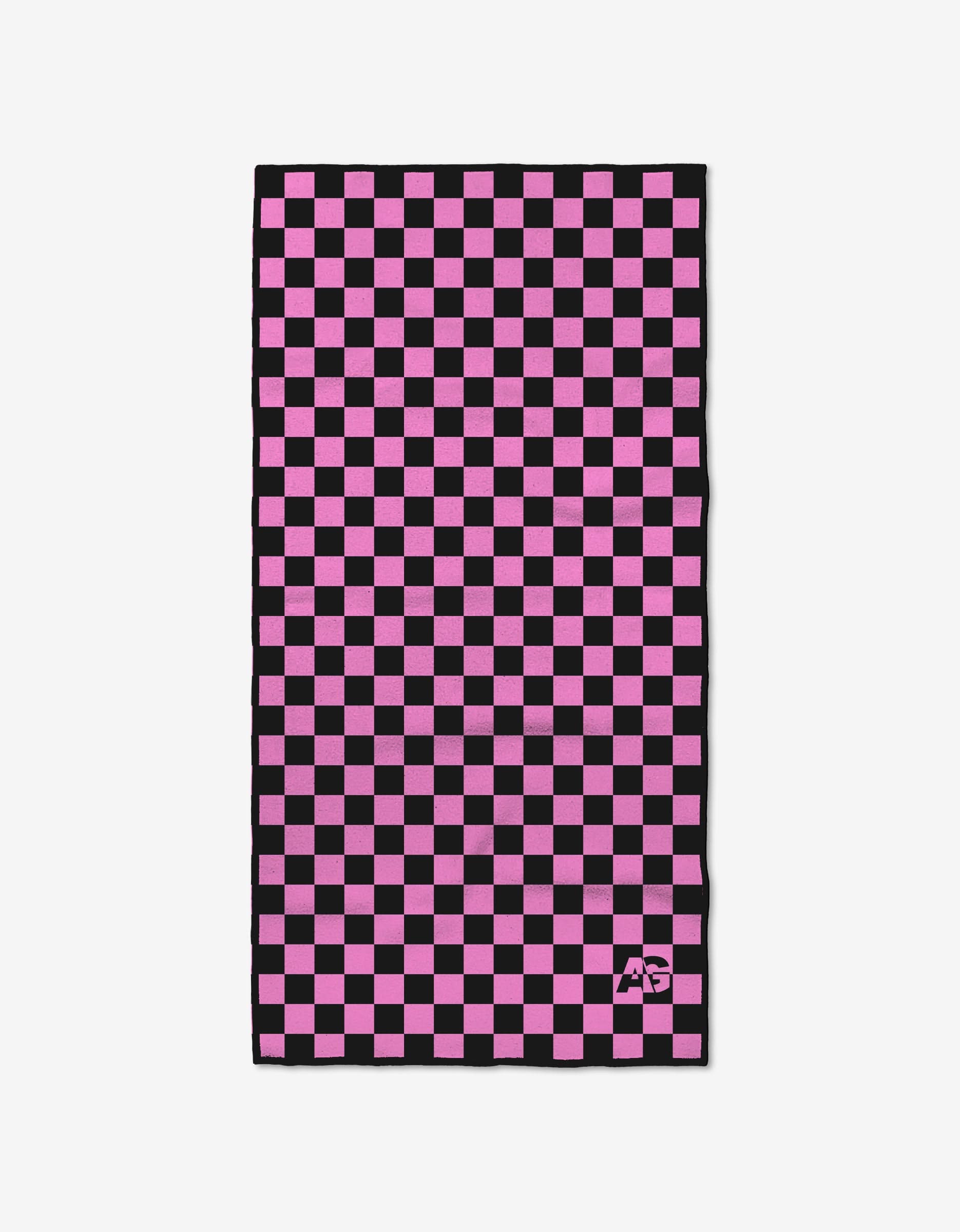 The Ashley Guarrasi Powder Puff is a rectangular fitness towel with a pink and black checkered pattern, crafted from ultra-absorbent recycled materials and featuring a small white logo in one corner, shown on a white background.
