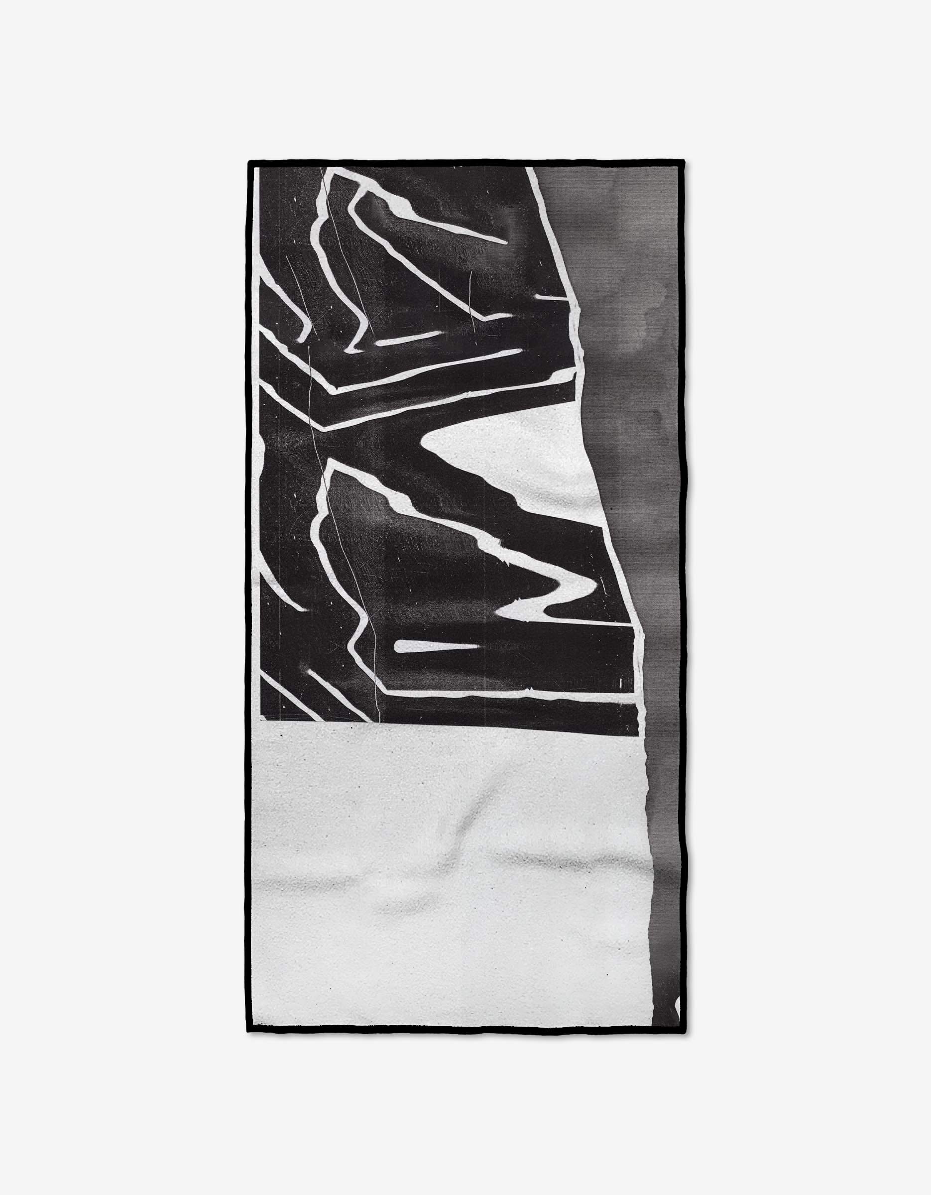 The Where rug by GEOMETRY showcases striking black-and-white abstract geometric shapes and lines on a plain background, crafted from recycled materials for a modern, eco-friendly statement.