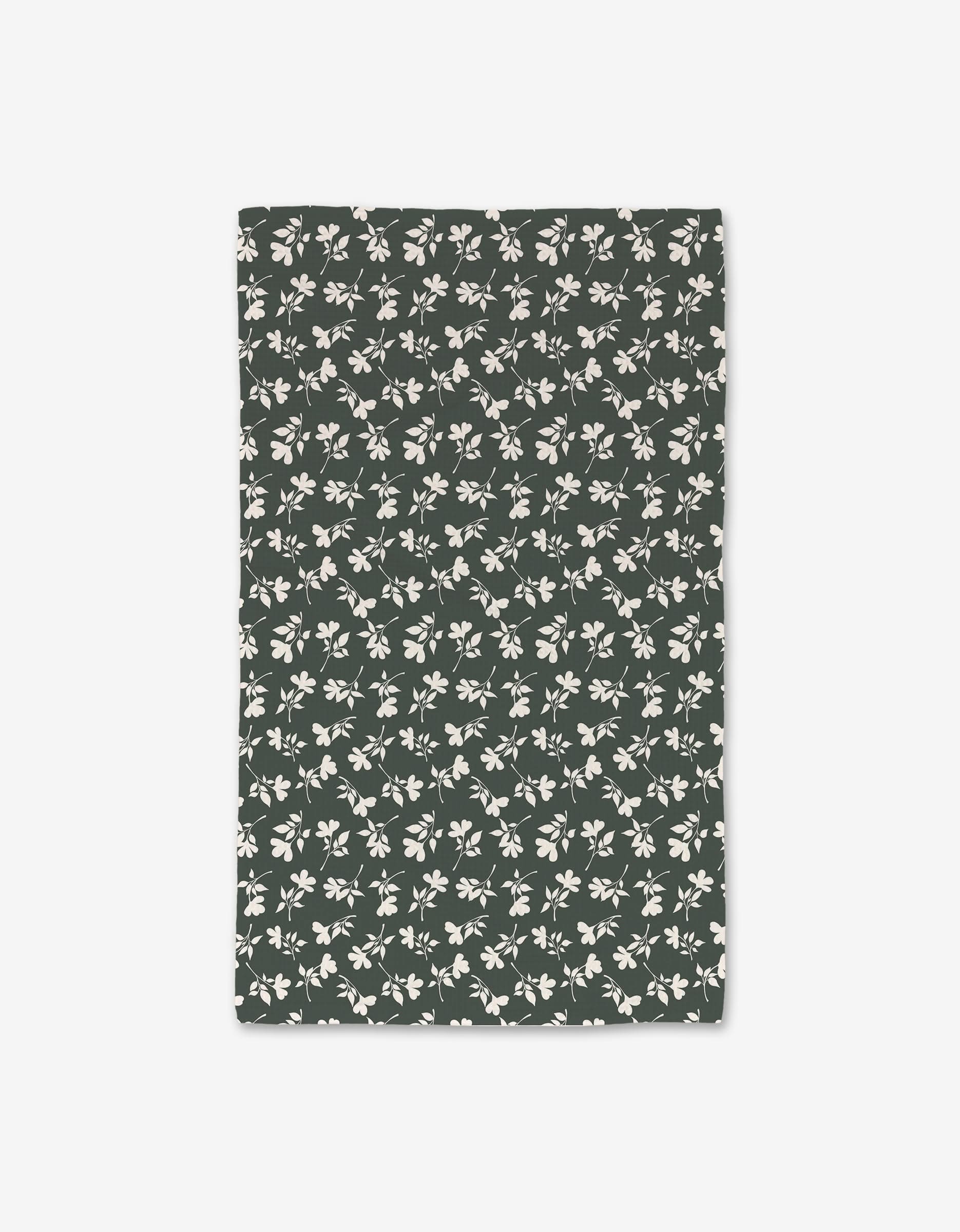 The Penelope by Charlie Rowan Designs is a rectangular dark green cloth with a repeating white floral and leaf pattern, made with ultra-absorbent Geoweave technology, shown flat on a white background.