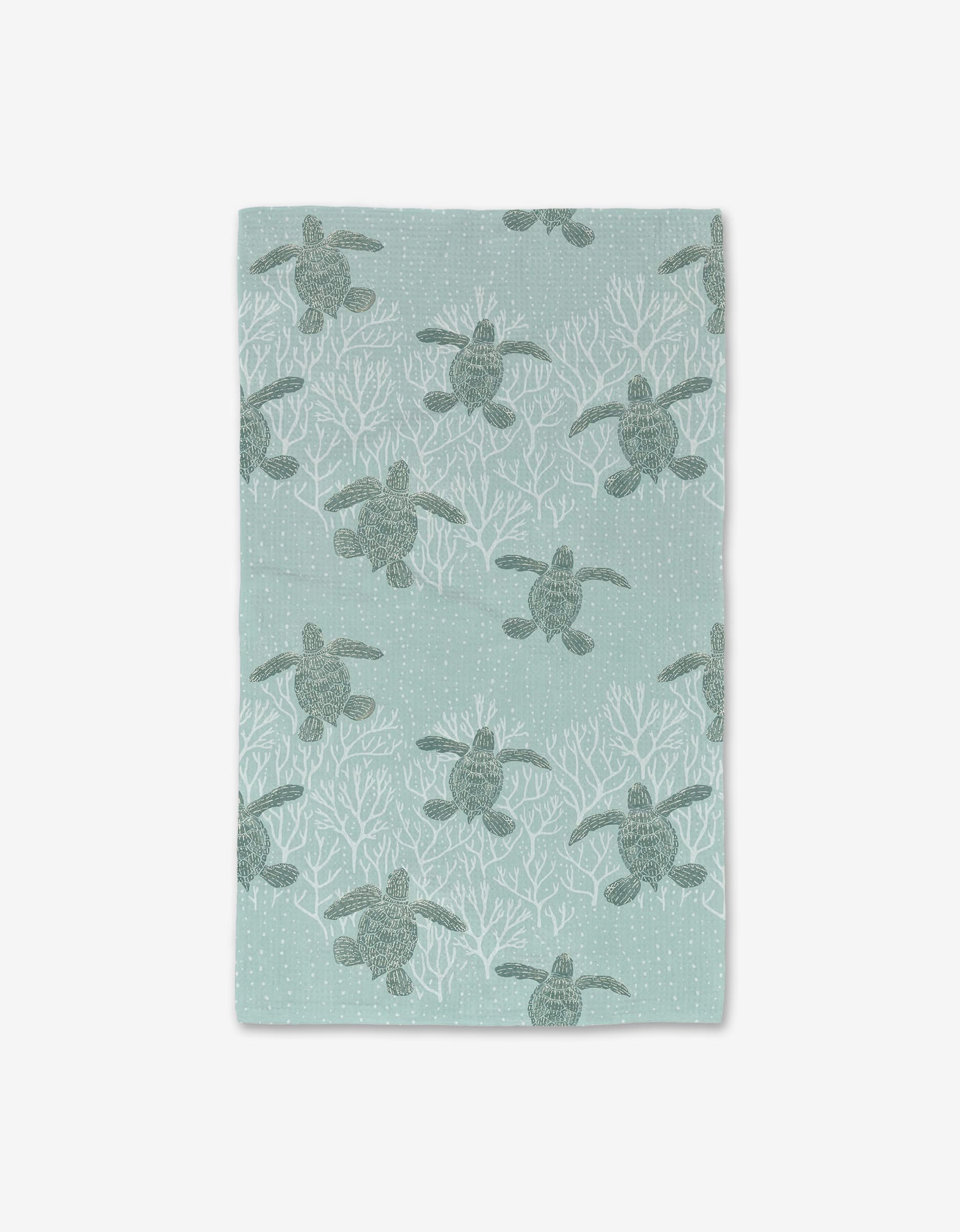 The Sea Turtles Luxe Hand Towel by Katie OShea features green sea turtles and white coral on a light blue background with dotted bubbles. Made with ultra-absorbent Geoweave technology, it adds charm to any space.