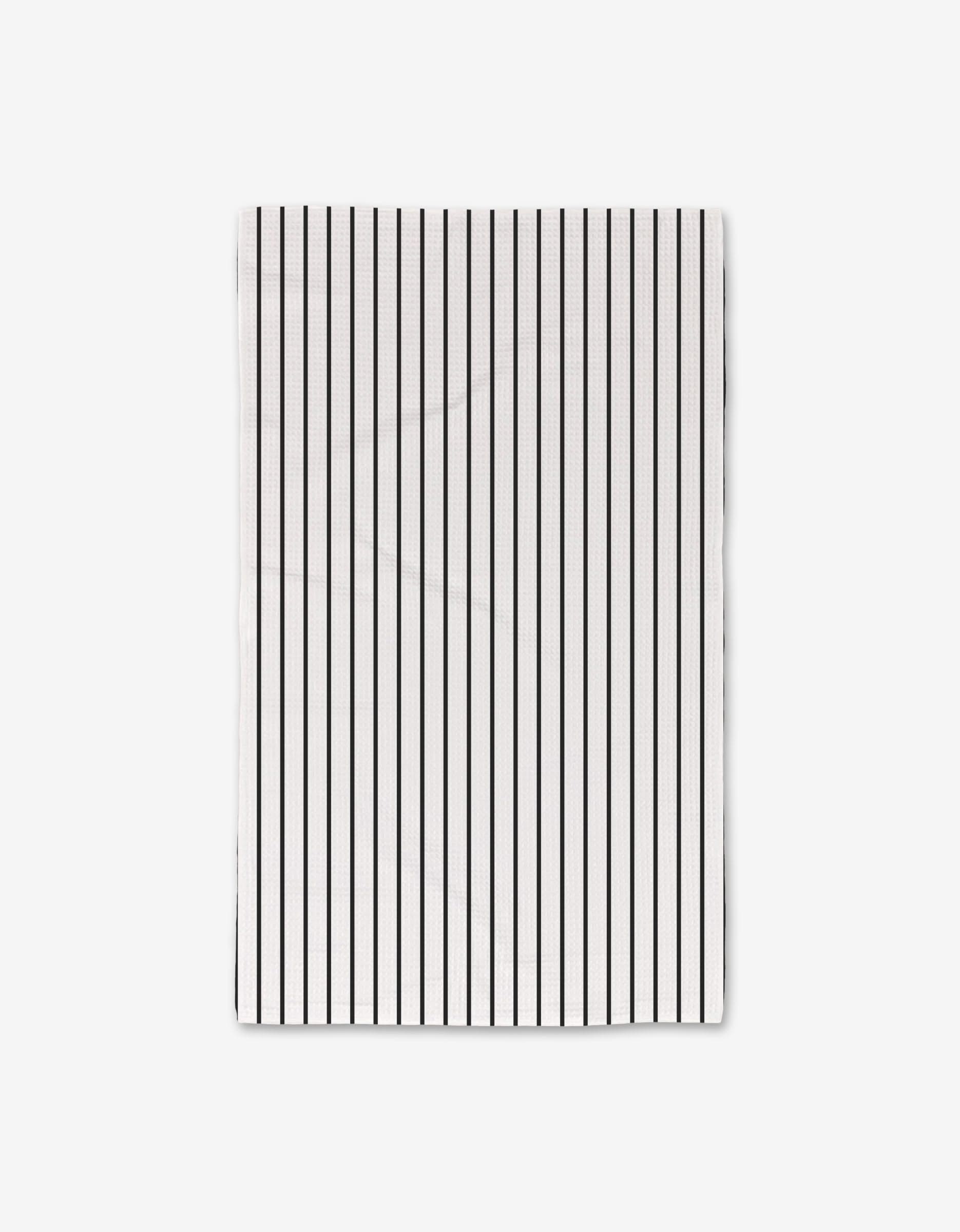 The GEOMETRY White Linen Luxe Hand Towel showcases evenly spaced vertical black stripes on white, made with ultra-absorbent Geoweave technology and displayed against a plain white background.