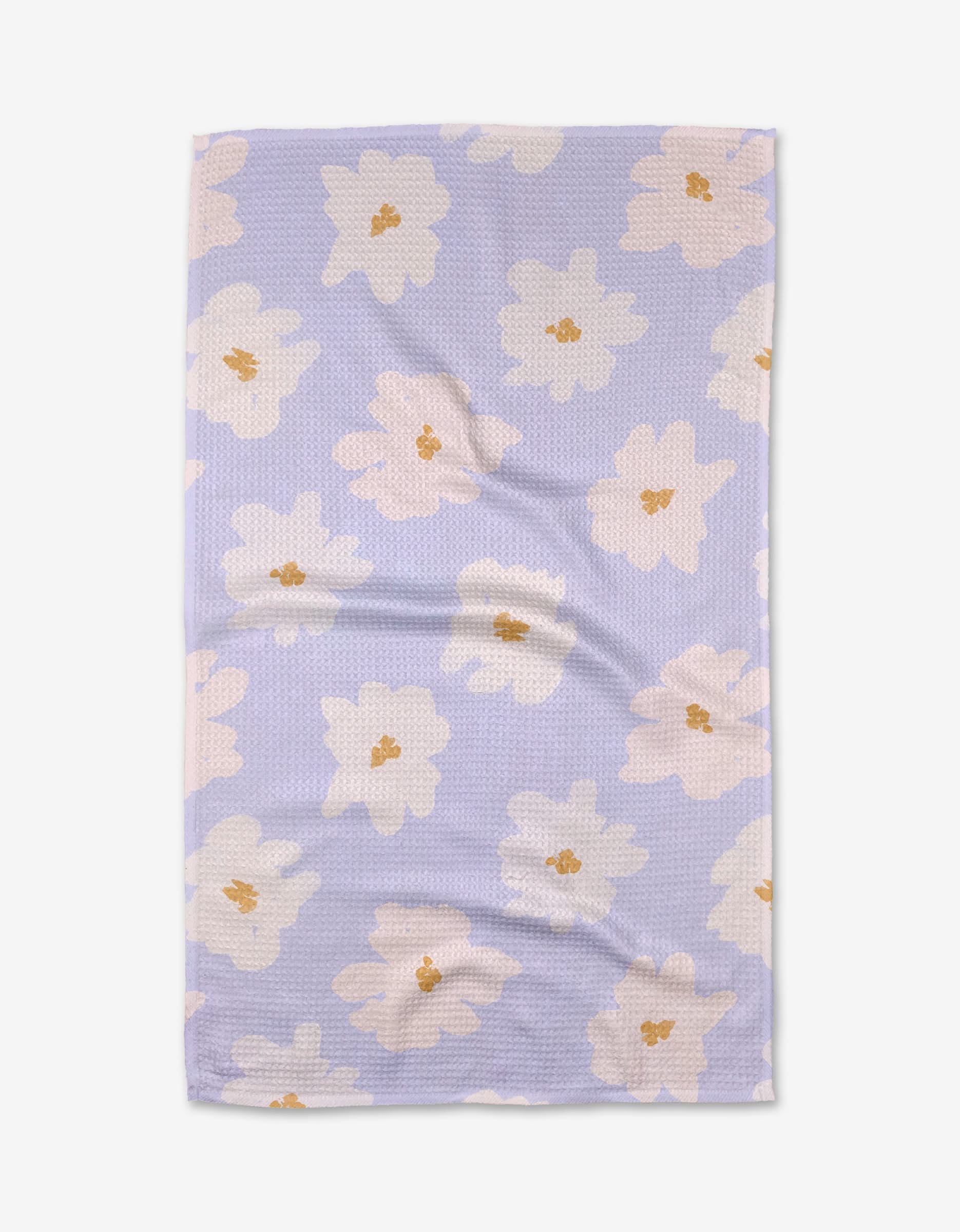 The Alpine Blooms tea towel by Mandy Arroyo features a rectangular shape in light purple Geoweave fabric with a textured surface and large white and beige flowers with yellow centers, shown on a white background.