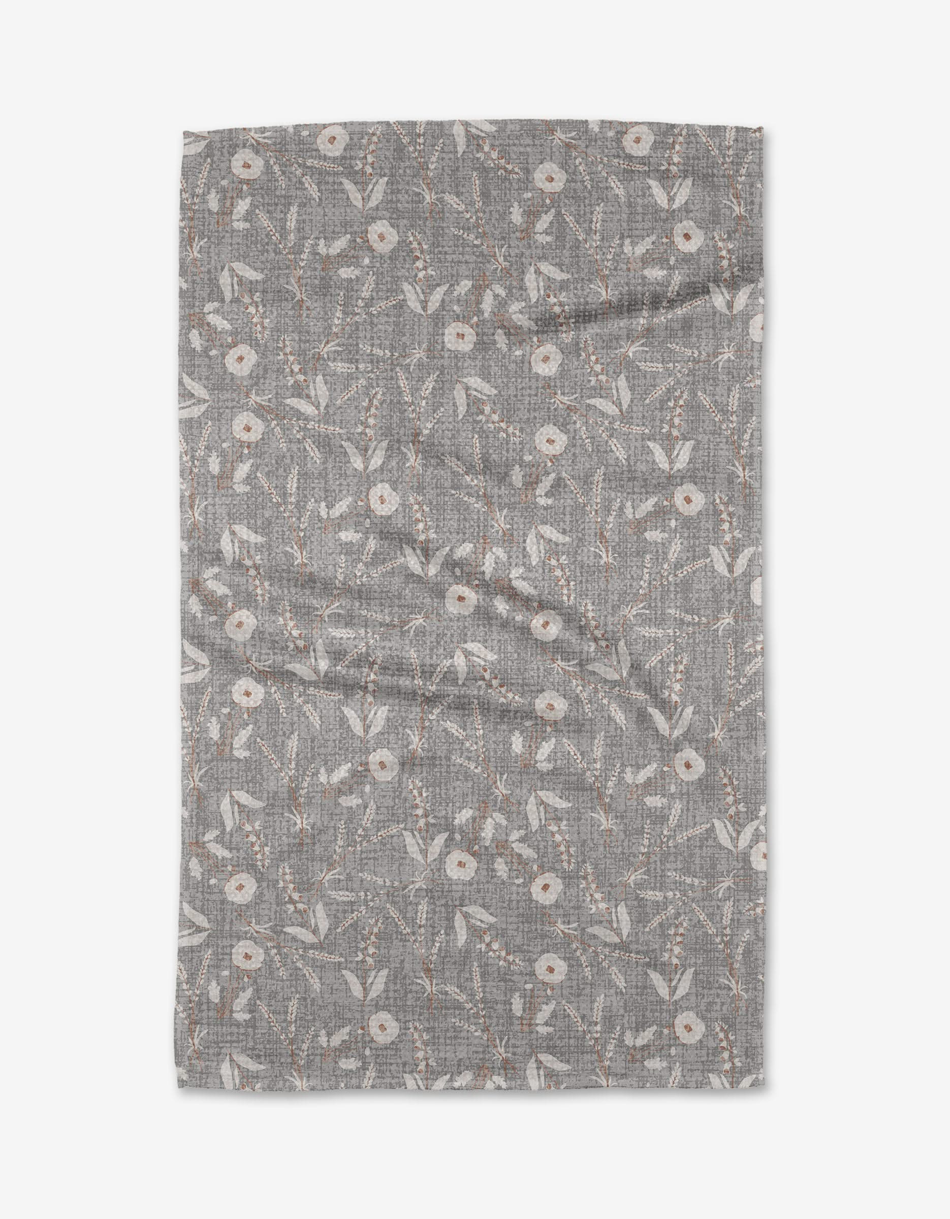 The Boyce Grey from Becki Owens is a gray Geoweave fabric featuring a white and brown floral leaf and round flower pattern, shown laid flat with some visible creases.