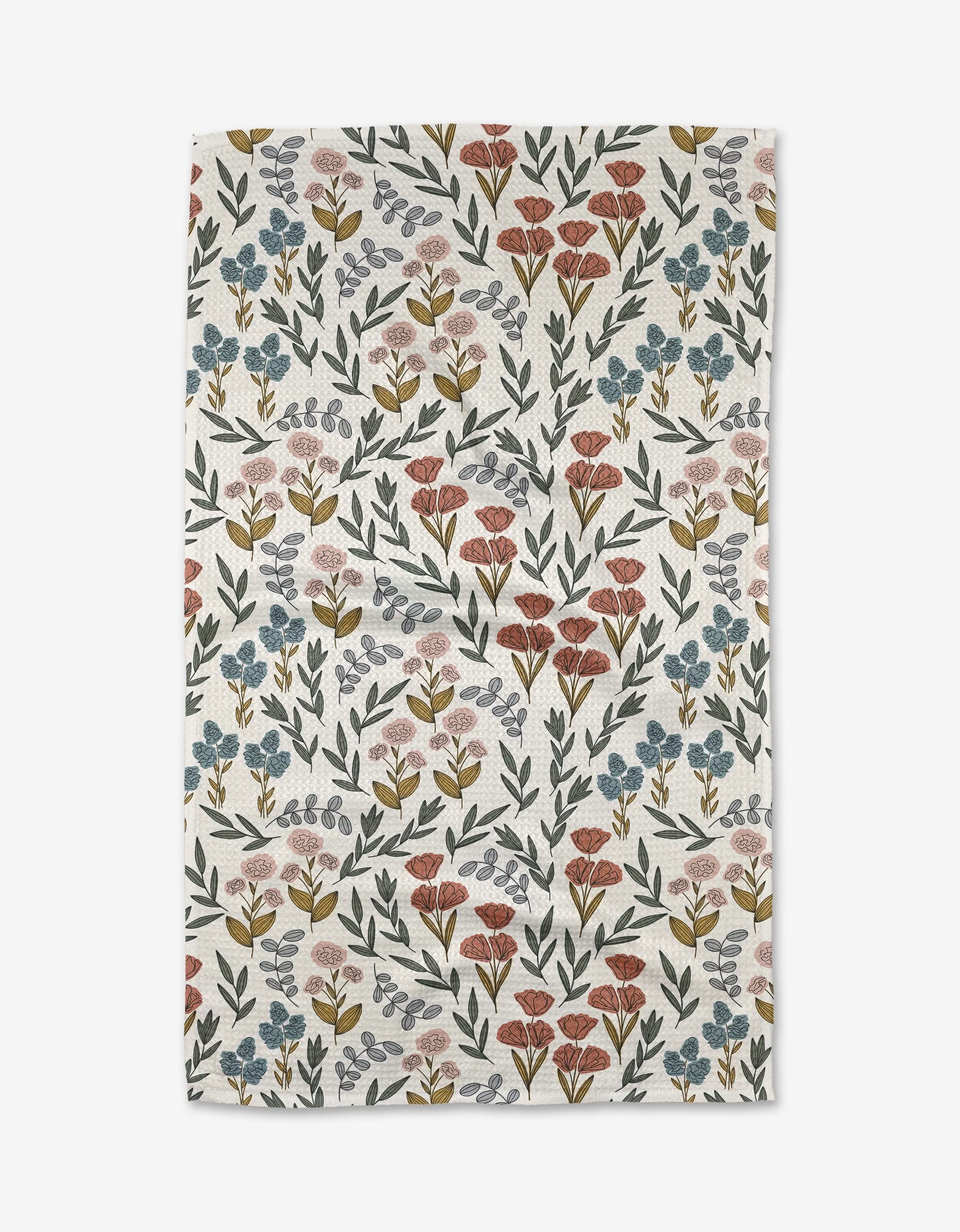The Charolette Multi by Charlie Rowan Designs is a white ultra-absorbent Geoweave cloth with a repeating pattern of red, blue, and pink flowers plus green and yellow leaves.
