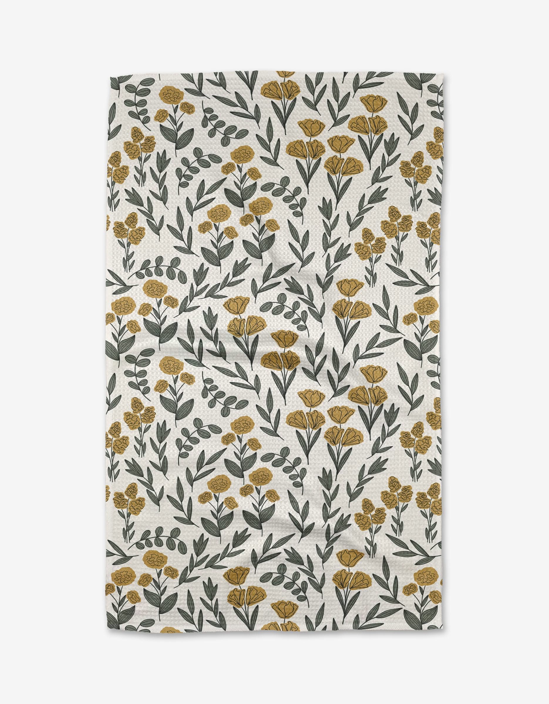 The Charolette Yellow tea towel by Charlie Rowan Designs showcases a scattered yellow floral and green leaf pattern on soft Geoweave fabric for enhanced absorbency and durability.