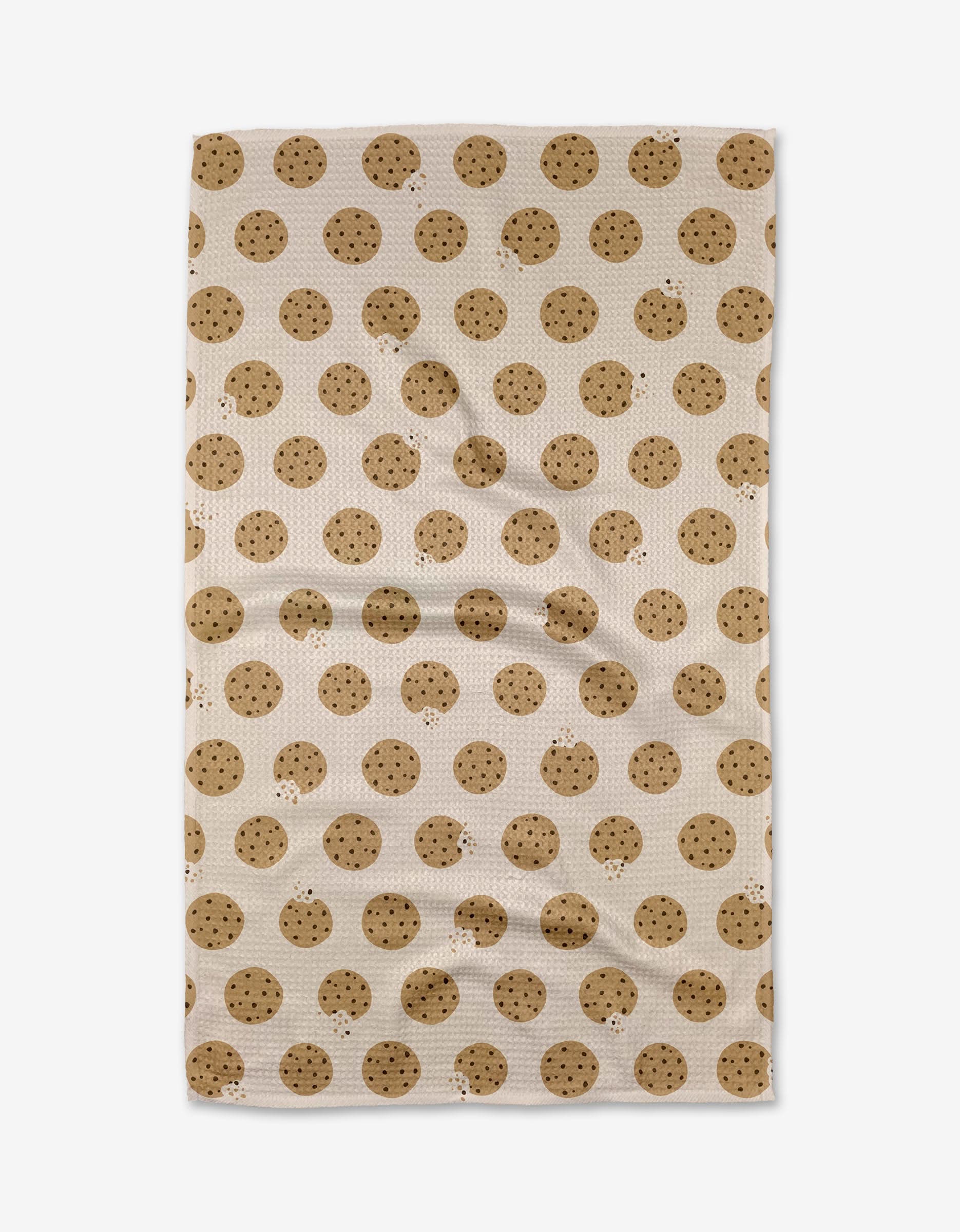 The Purely Kaylie Cookie Crumble tea towel, crafted from Geoweave fabric, showcases an all-over chocolate chip cookie pattern and is displayed flat.