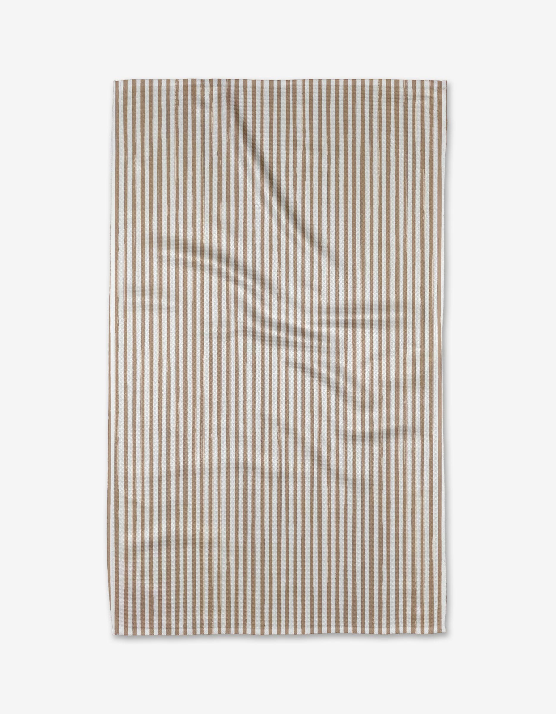 A beige and white vertically striped Kailee Wright Cookie Tea Towel, made from ultra-absorbent Geoweave™ fabric, is laid flat and shows natural folds and creases.