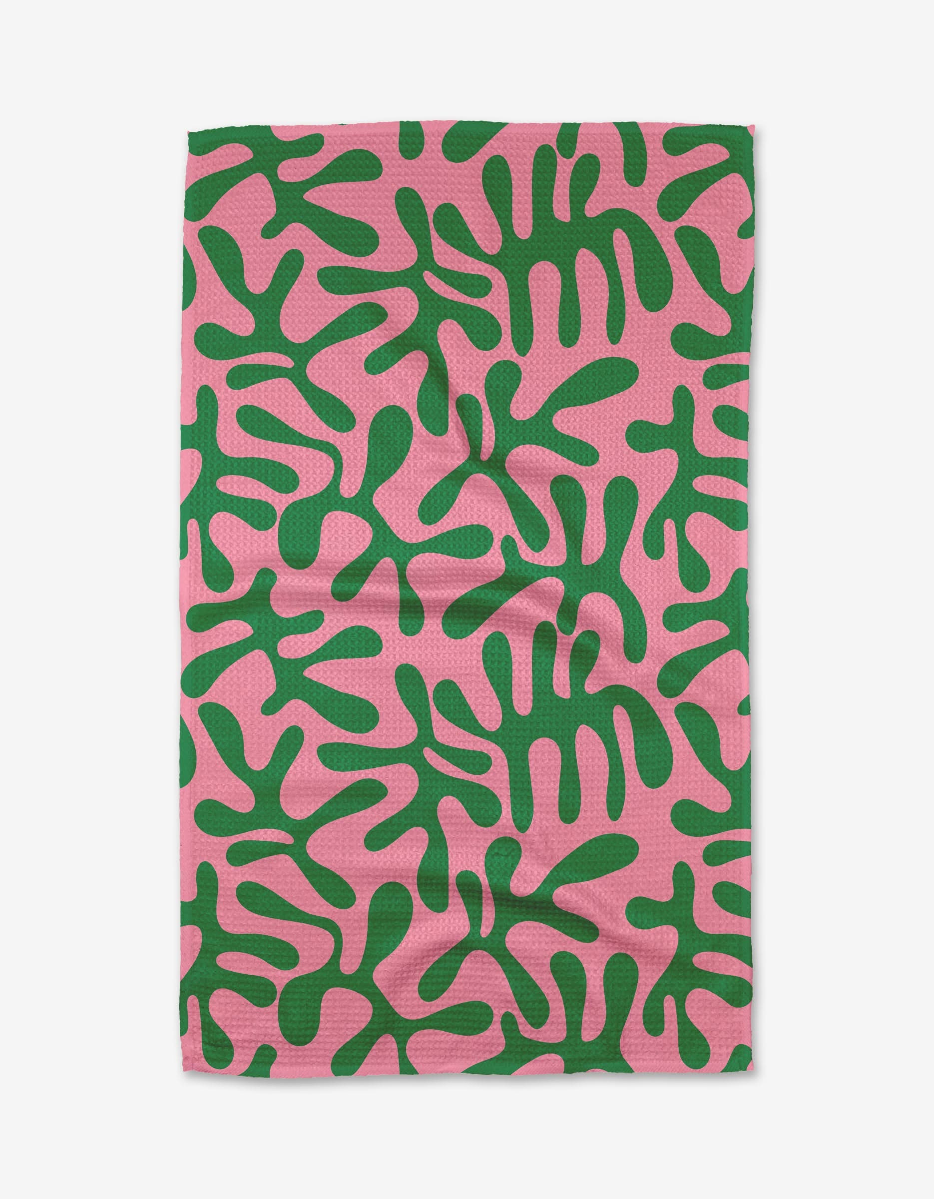 The Early Morning Plants tea towel by Marina Solodka features a rectangular design with an abstract green organic pattern on a pink background, made from recycled materials.