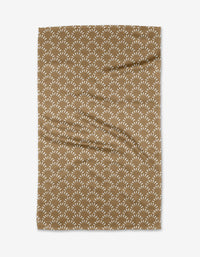 The Fantail towel by Hufton Studio is a brown, rectangular design with a repeating white fan-shaped pattern, made from ultra-absorbent materials and shown on a white background.